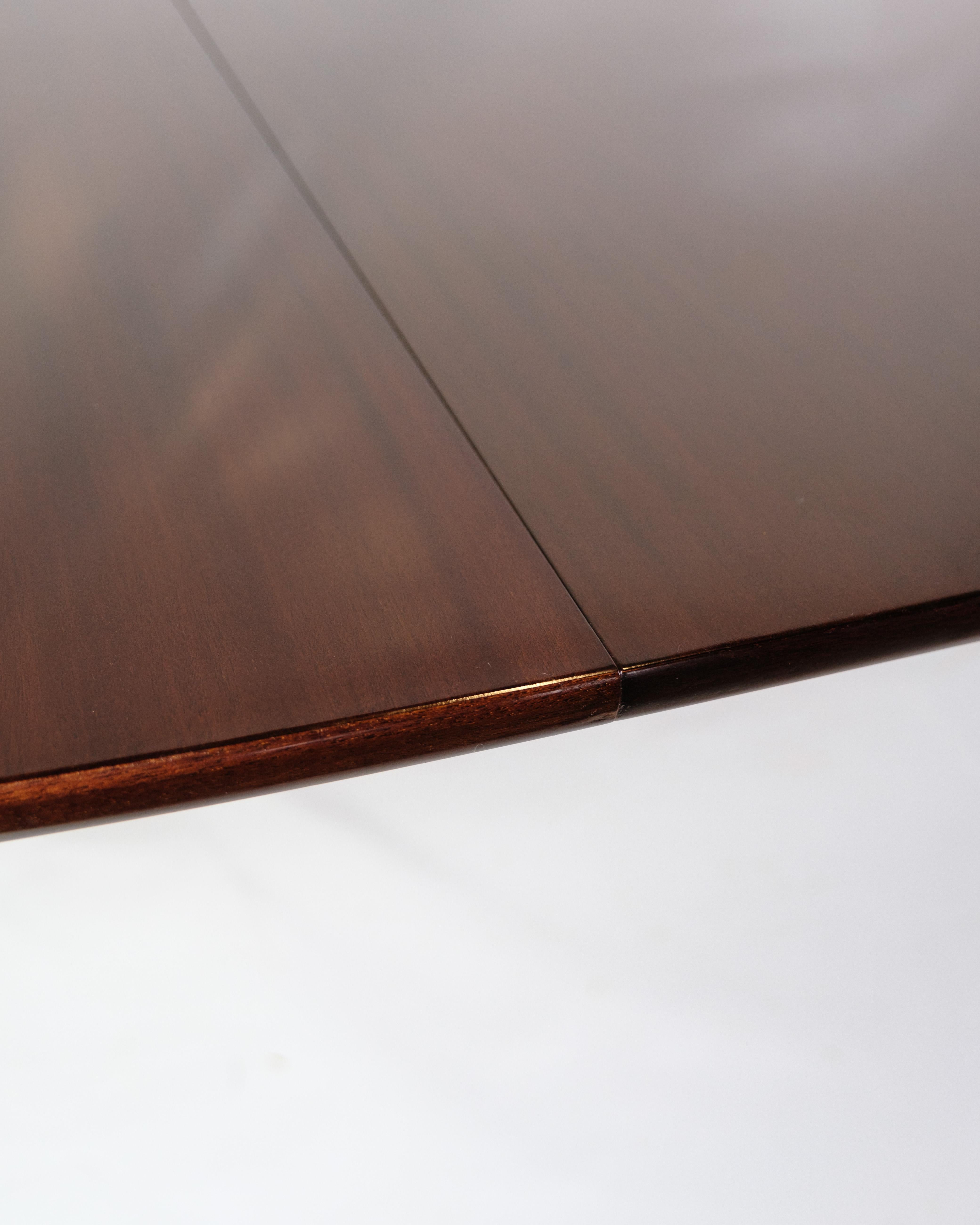 Dining table in mahogany, designed by Ole Wanscher and produced by P. Jeppesen in the 1960s. The table is made of solid mahogany, which gives it an elegant and classic appearance. Ole Wanscher was known for his refined design and his focus on