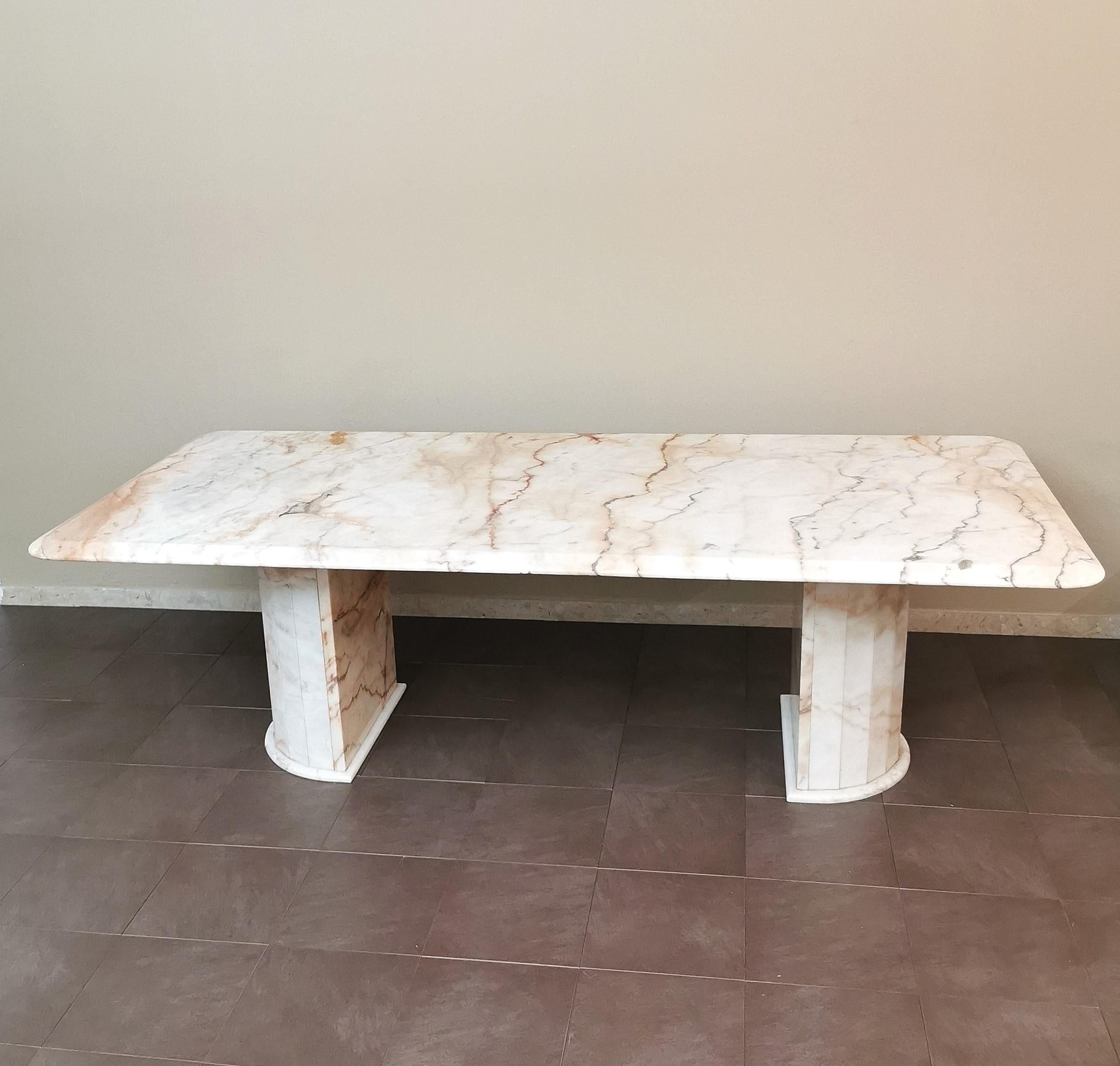 Imposing dining table produced in Italy in the 70s. The table was made with a large rectangular pink and white marble top with a beveled border that rests on two columns in the shape of a semicircle, also in pink and white marble.



Note: We try to