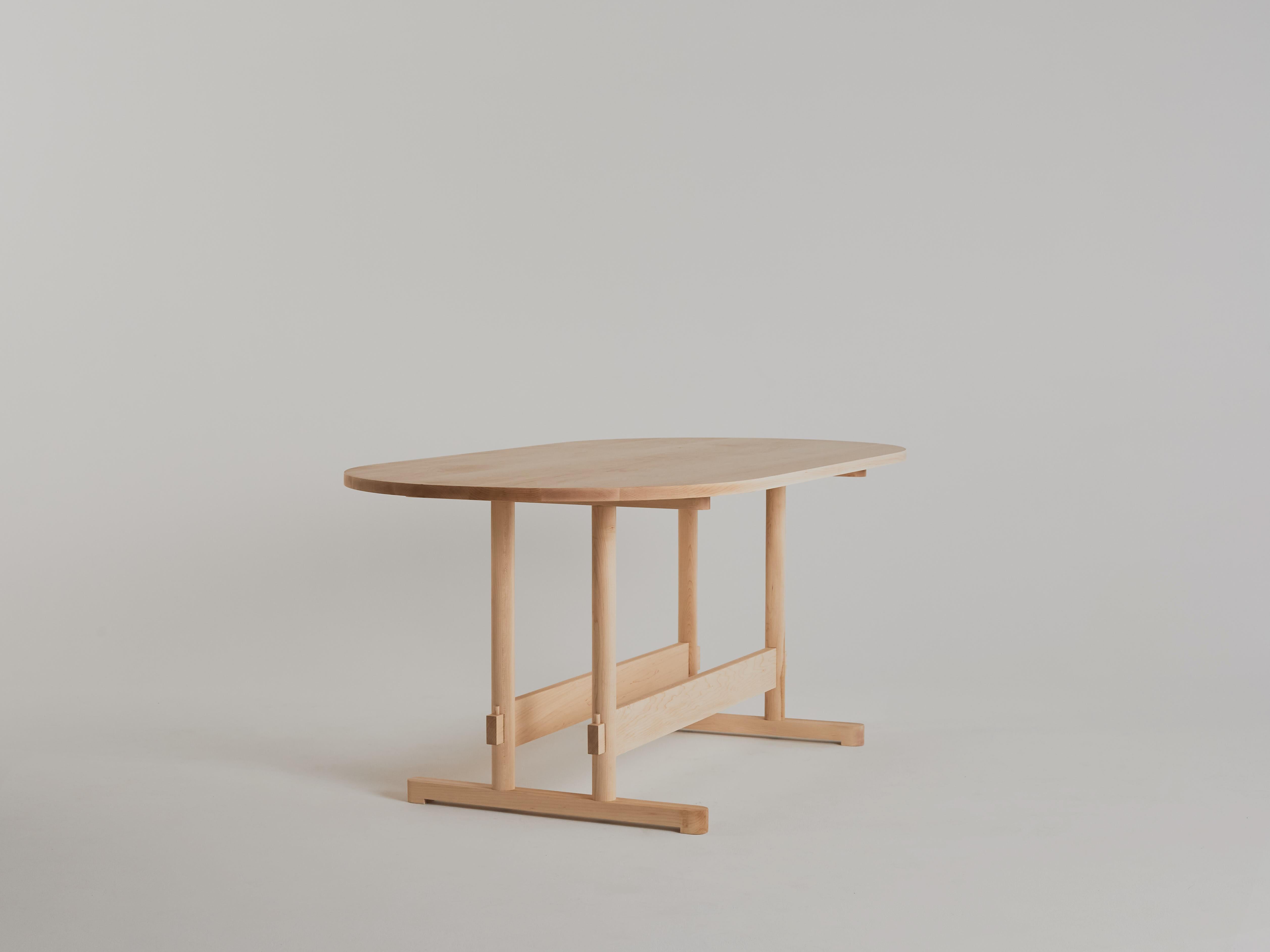 Dining table no. 2 by Campagna, shown in Maple. 

This updated take on the classic trestle dining table is visually light and minimal, while carrying sophisticated details and clever joinery. The leg structure and stretchers are connected using
