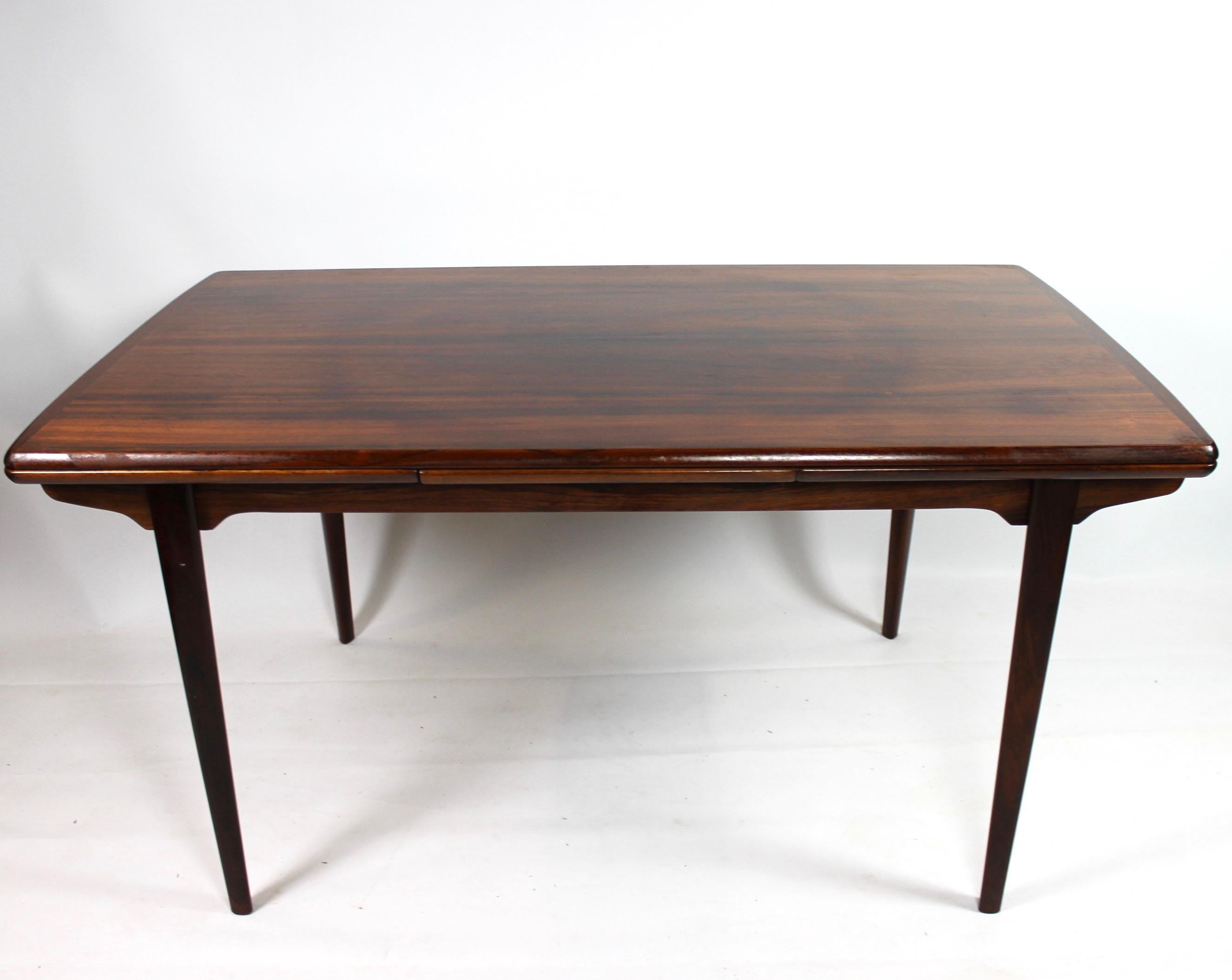 Dining table of rosewood with Dutch extension designed by Arne Vodder from the 1960s. The dining table is in great vintage condition. Total length is 240cm. Each extension plate is 50cm. The shortest length is 140cm. It is a table of very high