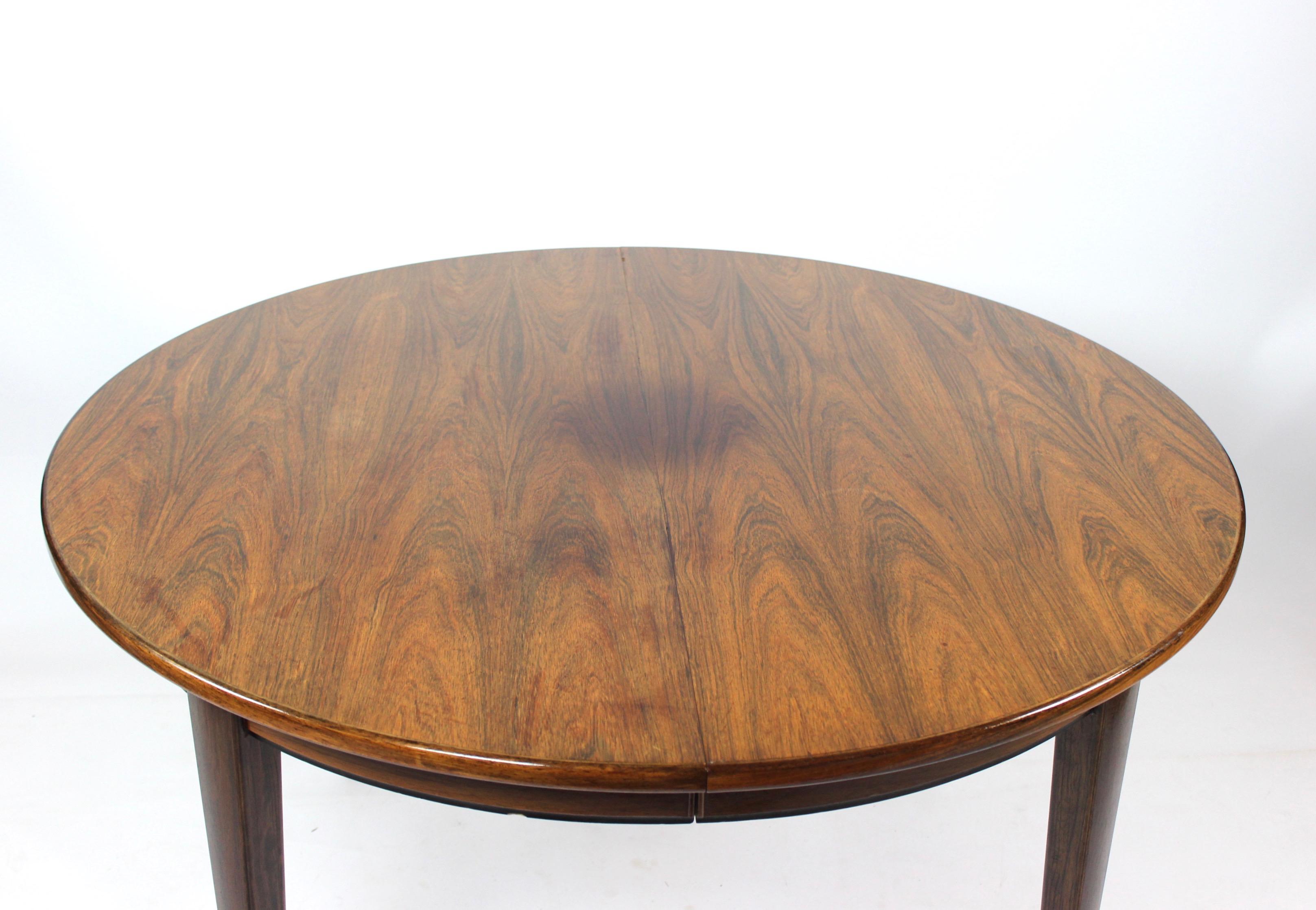 Elegance of mid-century design with this remarkable dining table crafted by Omann Junior in the 1960s. Constructed from luxurious rosewood, this table exudes timeless sophistication while offering exceptional functionality.

A hallmark of