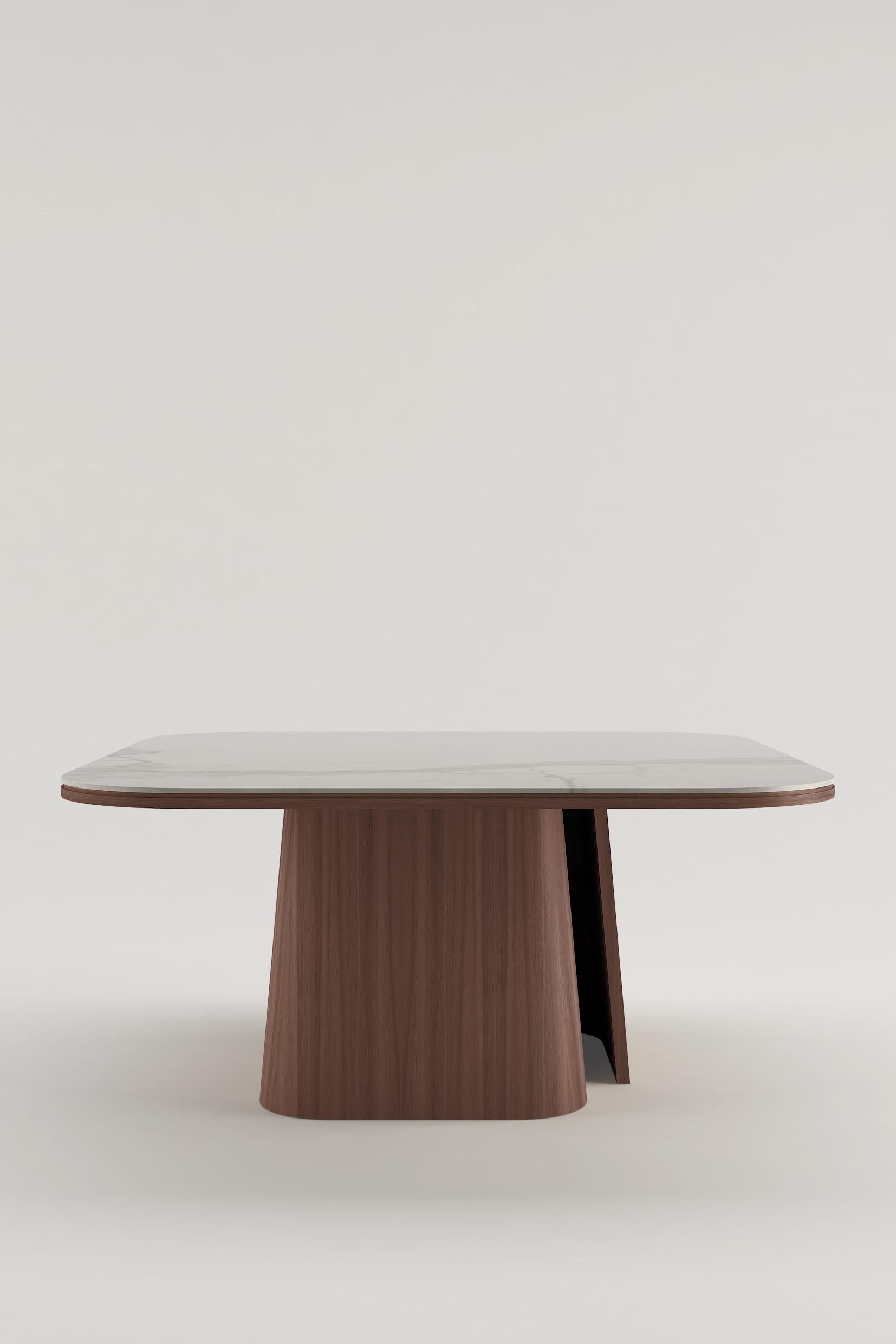 Dining table with American Walnut legs and Calatta marble top.

The OOMA table is not just a piece of furniture, but a sensation of immediate purity, offering a break from the chaos of the world to create order, space and clean lines. Designed by
