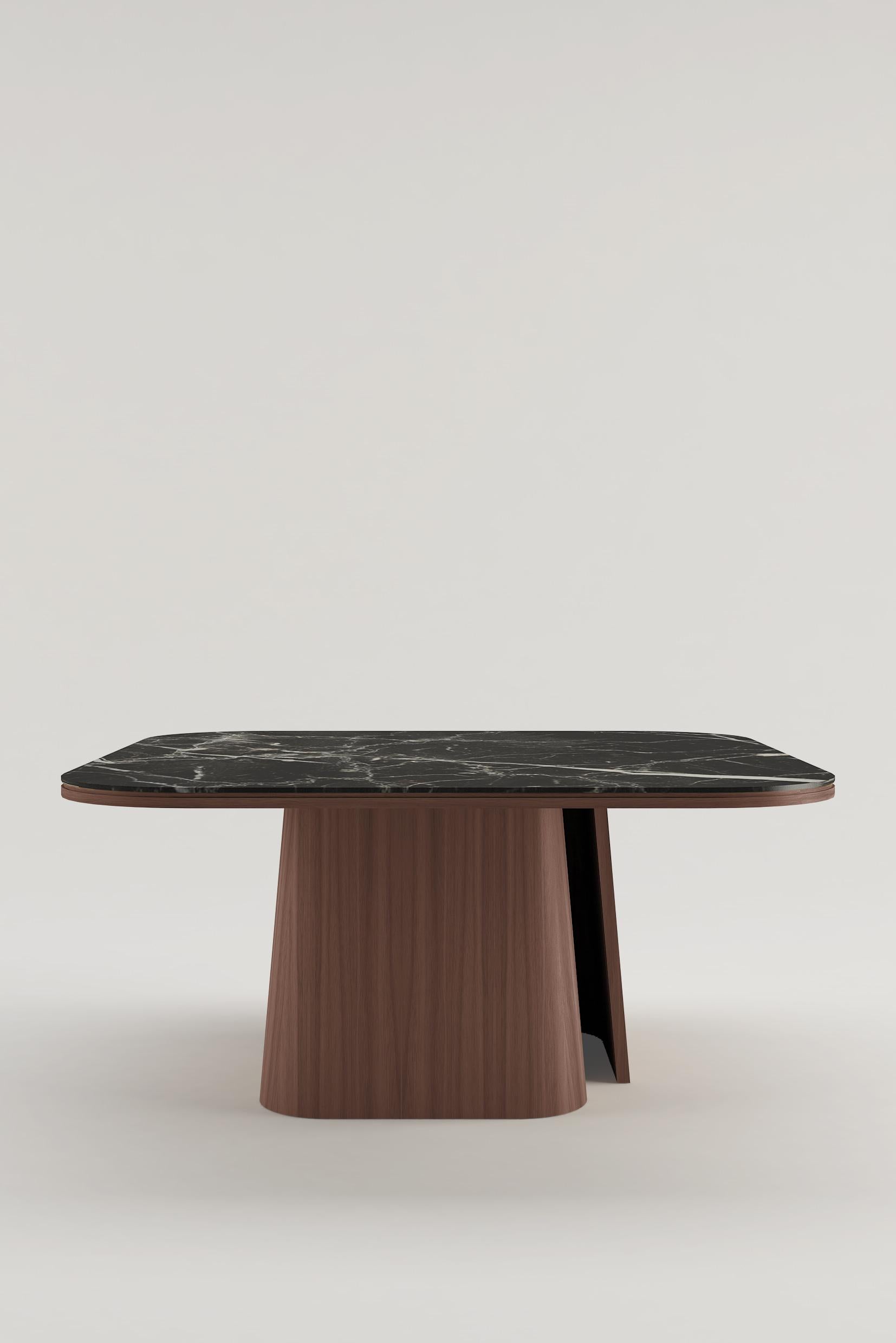 Mesa de comedor con patas de nogal americano y tablero de mármol Nero Marquina.

La mesa OOMA no es sólo un mueble, sino una sensación de pureza inmediata, que ofrece una ruptura con el caos del mundo para crear orden, espacio y líneas limpias.