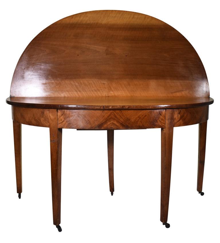 Classic Rich walnut table with straight tapering legs, brass casters, and striking wood grain of apron. The table can be used as a demilune against a wall or open the top to use as an oval table.

Dimensions below are when closed.  

Dimensions