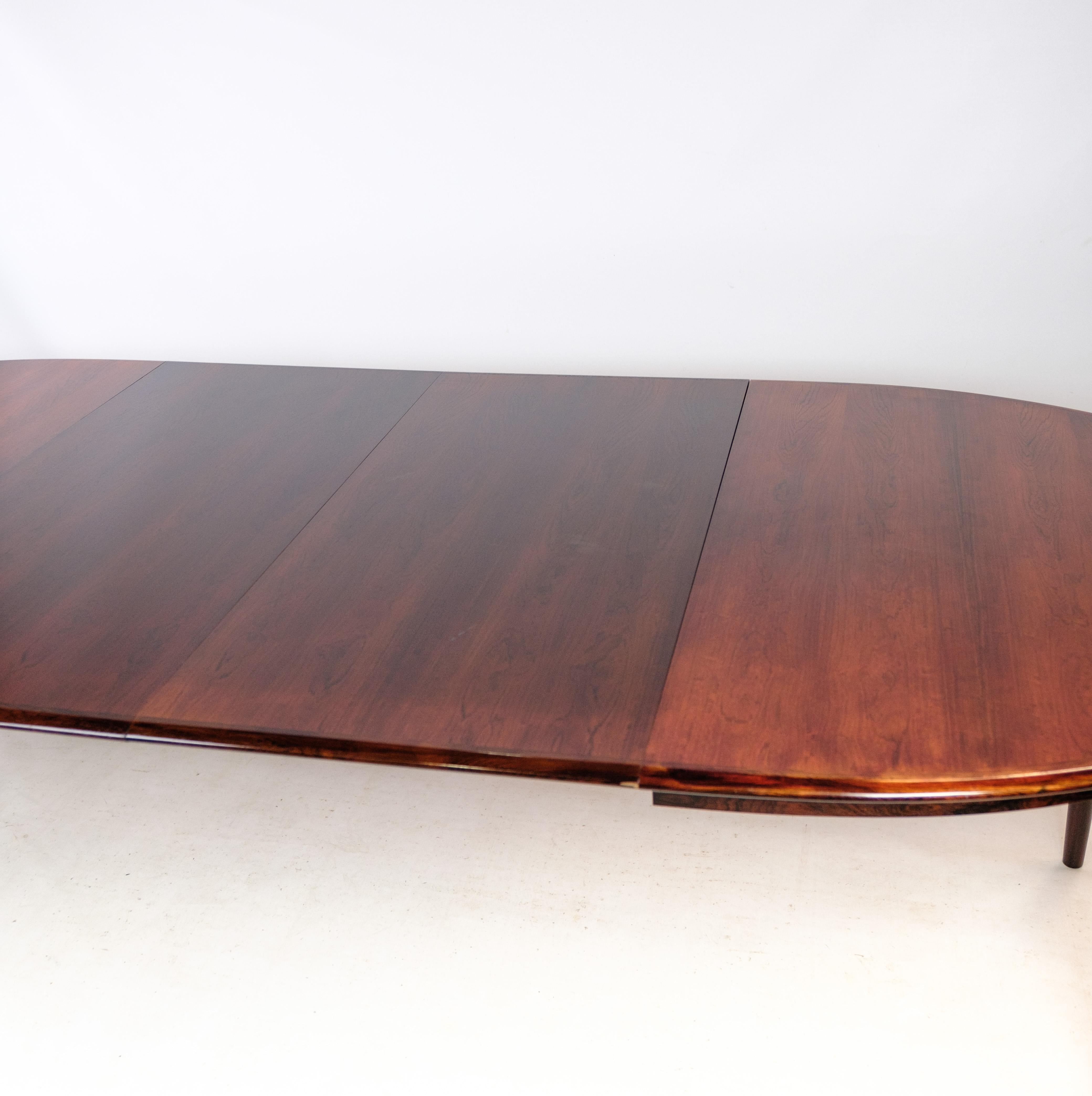This oval dining table, designed by the acclaimed Arne Vodder, epitomizes the elegance and sophistication of mid-century Danish design. Crafted from rosewood and dating back to around the 1960s, this table is a timeless piece that adds a touch of