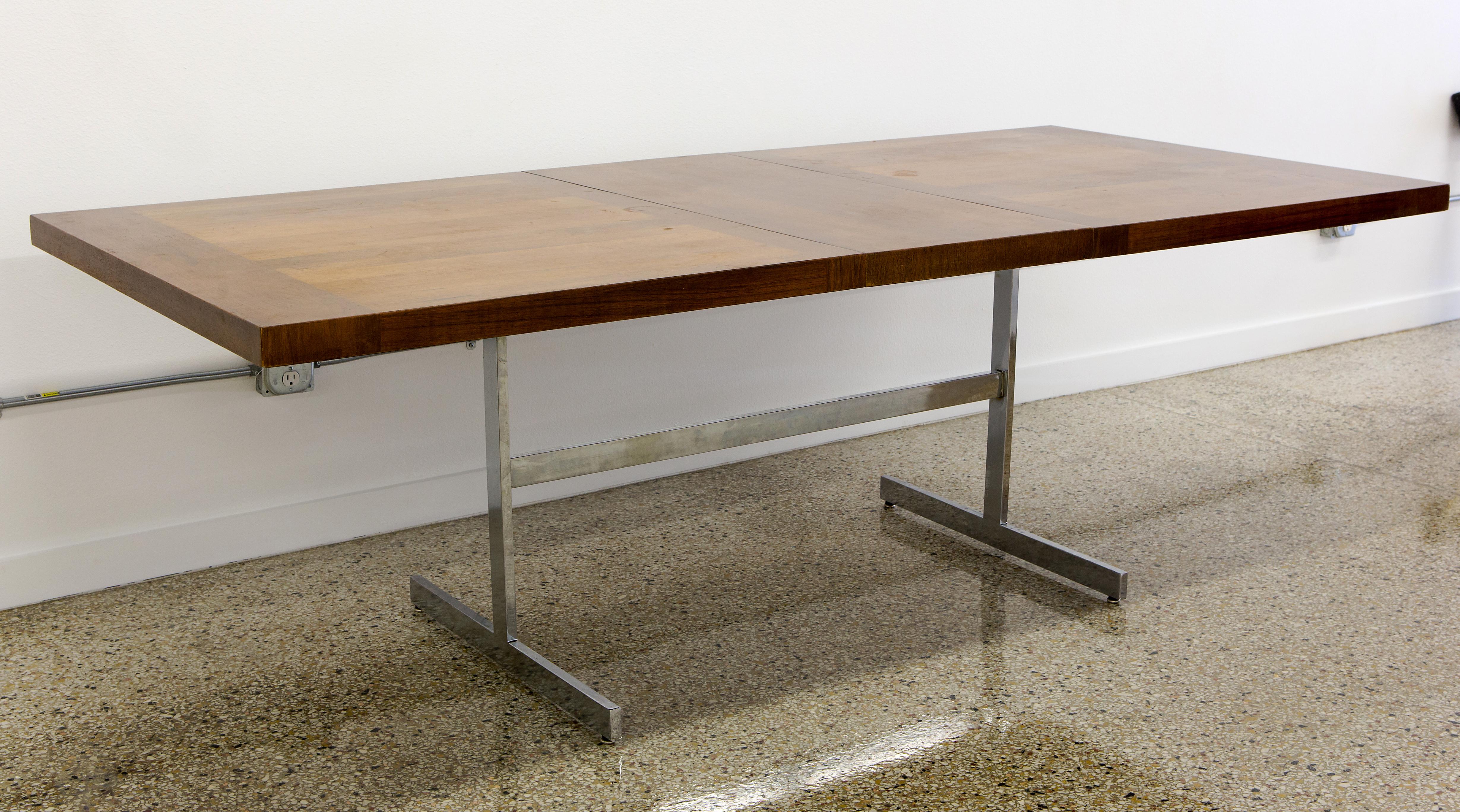 Dining table of rosewood with one leaf extension on chrome steel base. Designed by Alfred Hendrickx for Bellform Furniture, Belgium, circa 1960s. This table represents Hendrickx's classic combination of a fine wood teak top with an industrial steel