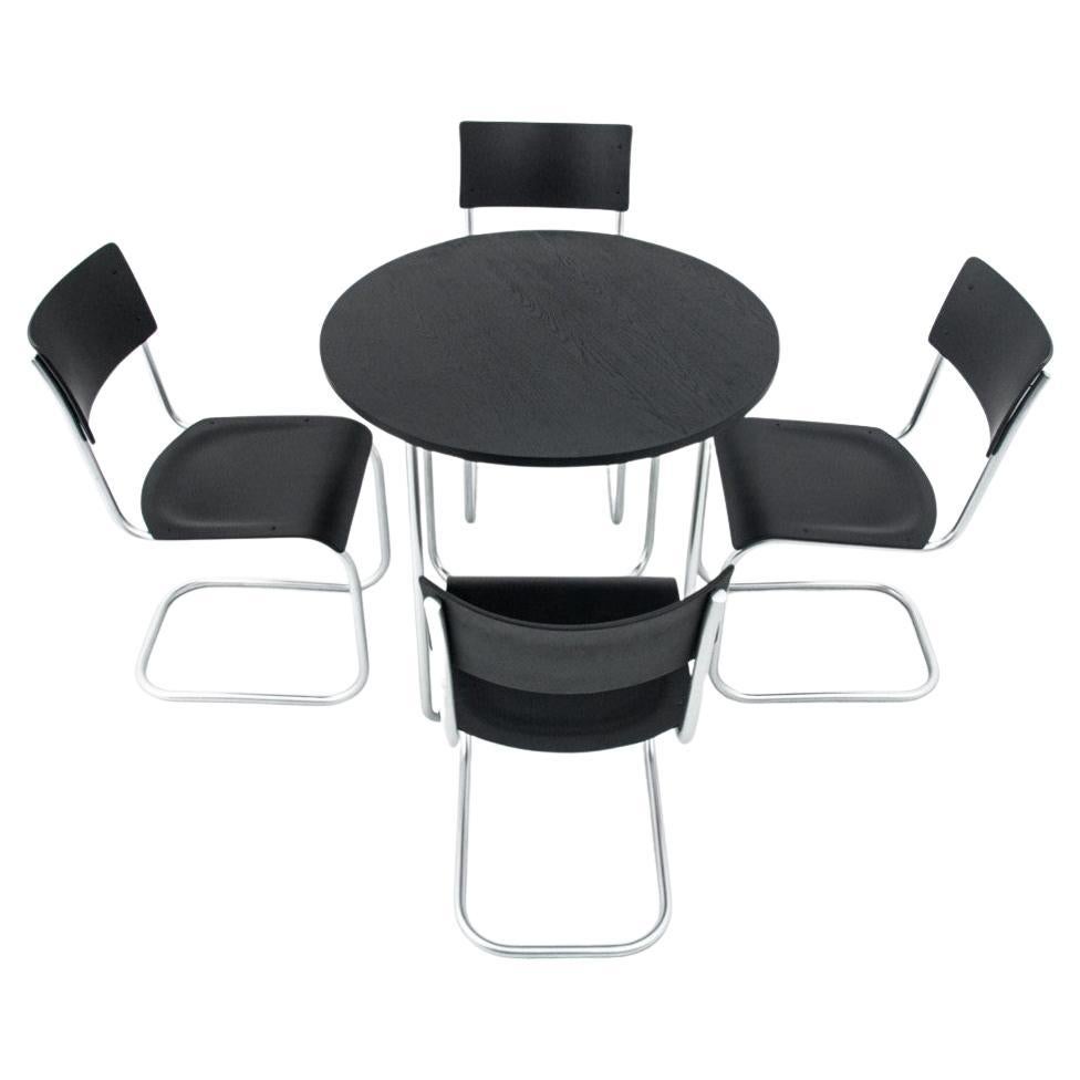Dining table set table + 4 chairs by Marta Stama, Poland, 1930s

The chairs and the table were designed by Marta Stam, a Dutch architect and Bauhaus lecturer, and were made at the East Steel Furniture Factory in Zajiel near Żywiec. It is a type of