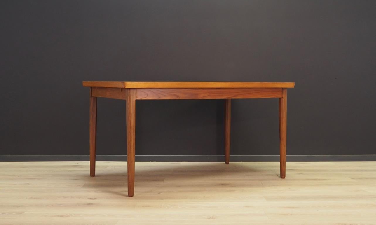 Classic table from the 1960s-1970s, a beautiful Minimalist form - Danish design. Tabletop veneered with teak, solid teak wood legs. Item has two inserts under the countertop. Preserved in good condition (visible bruises and tracing) - directly for
