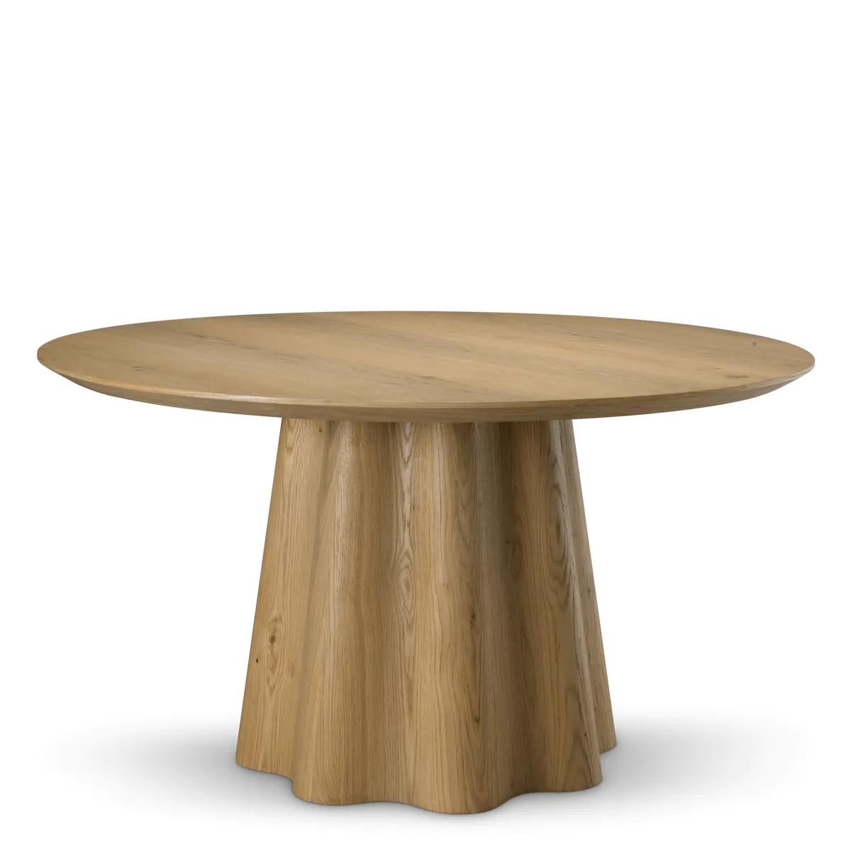 The Dining Table is a sculptural dining table crafted from warm oak veneer with a rich open grain. This table combines timeless elegance with organic geometry. Its solid yet graceful base recalls the form of a classical column, making the dining