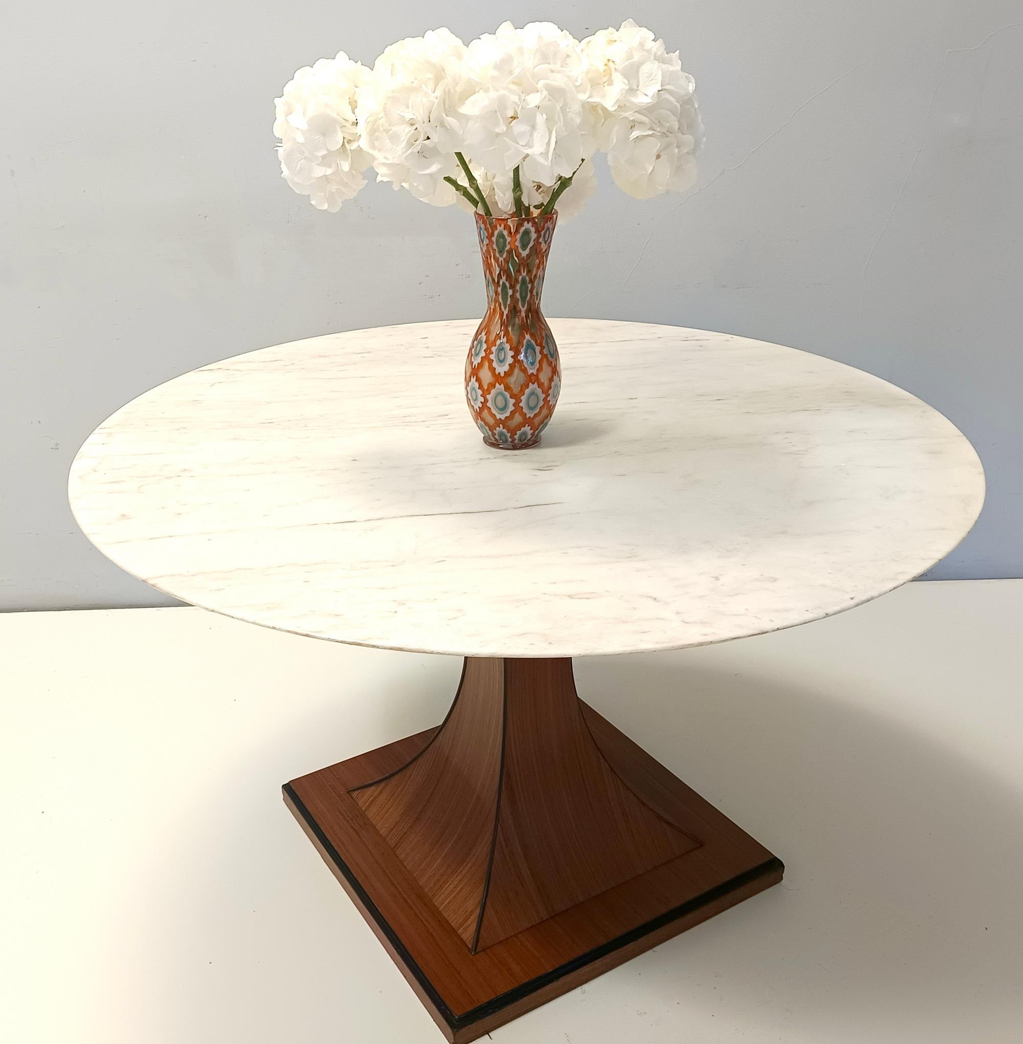 Il se compose d'un plateau en marbre rose portugais et d'un piédestal en noyer Canaletto ébonisé.
Cette table est parfaite pour 6 personnes.  
Il peut présenter de légères traces d'utilisation puisqu'il est vintage, mais il peut être considéré comme