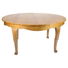 Dining table with additional plates made of birch wood from around the 1920s