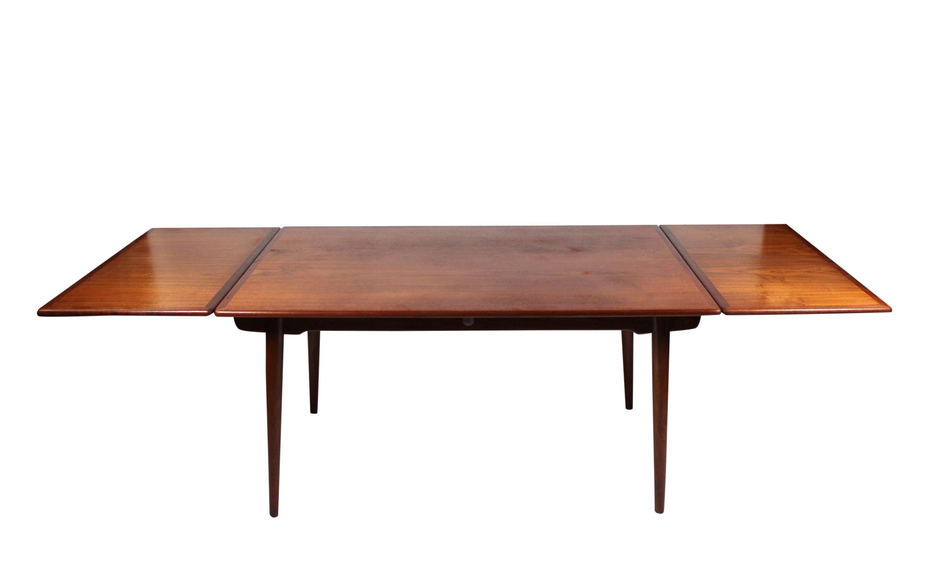 Elegant Dining Table with Extensions in Teak, a timeless creation by renowned designer Hans J. Wegner and masterfully crafted by Andreas Tuck in the 1960s.

This exquisite dining table embodies Wegner's signature blend of functionality and beauty.
