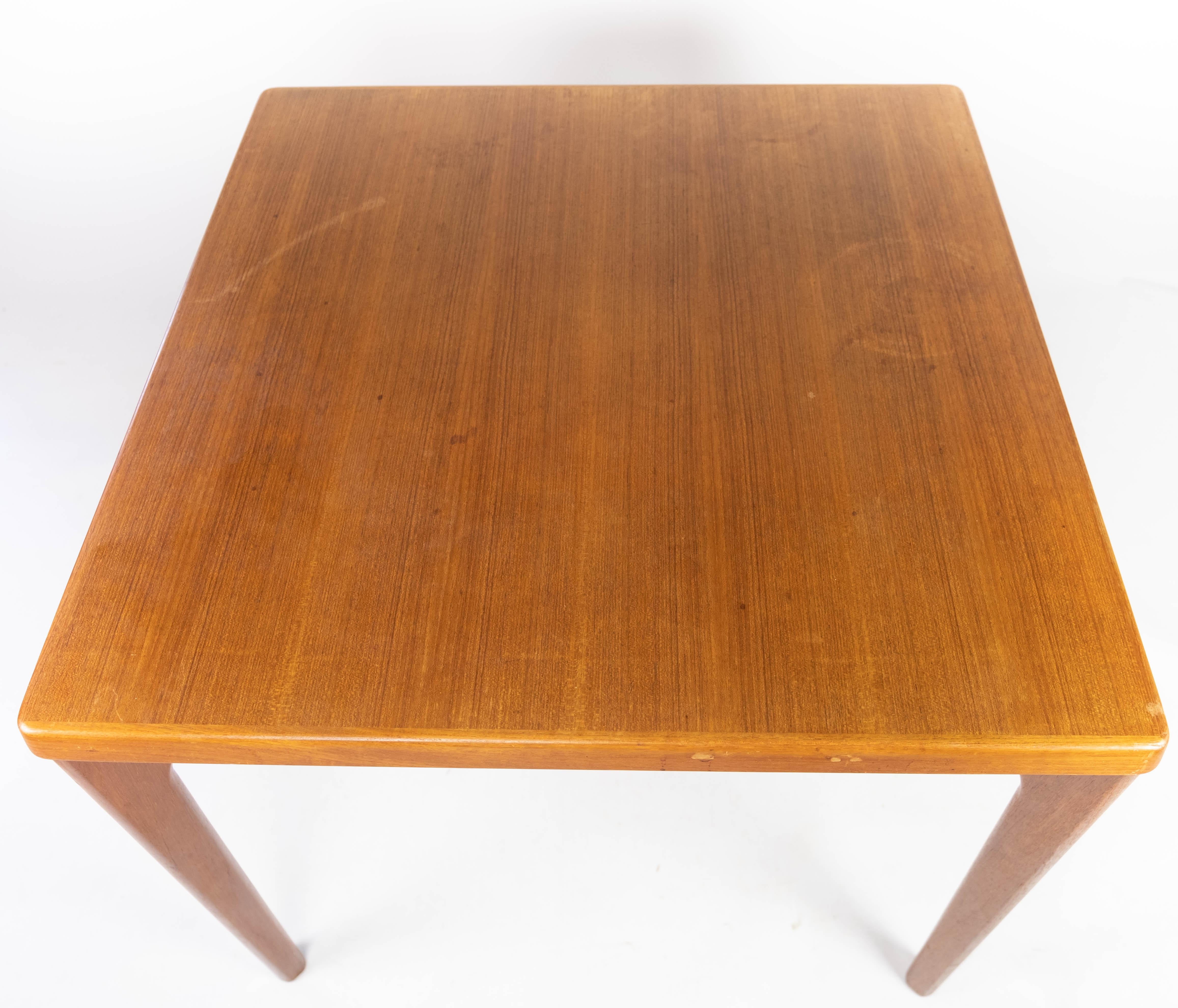 This teak dining table, designed by Henning Kjærnulf and crafted by Vejle Stole & Møbelfabrik in the 1960s, epitomizes the enduring elegance of Danish design. Its sleek and minimalist silhouette exudes a timeless appeal, while the warm hues and rich