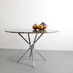 Dining table with folding chrome-plated metal scissor legs and Emperador marble