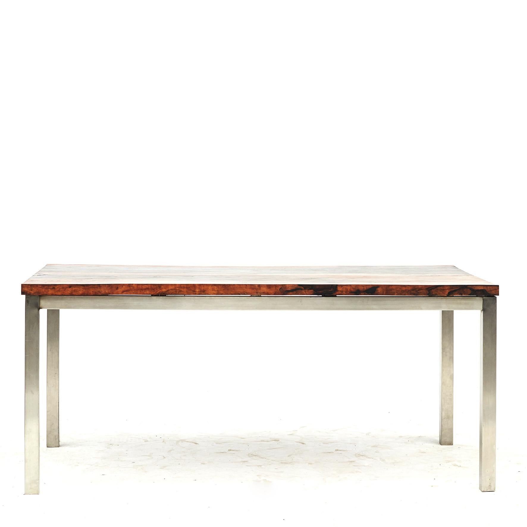Rectangular dining table.
The top is made from two old pieces of Narra hardwood with beautiful grain.
Base of brass / chrome which gives it an industrial edge.

Narra is the national tree of the Philippines and a tropical hardwood tree, often