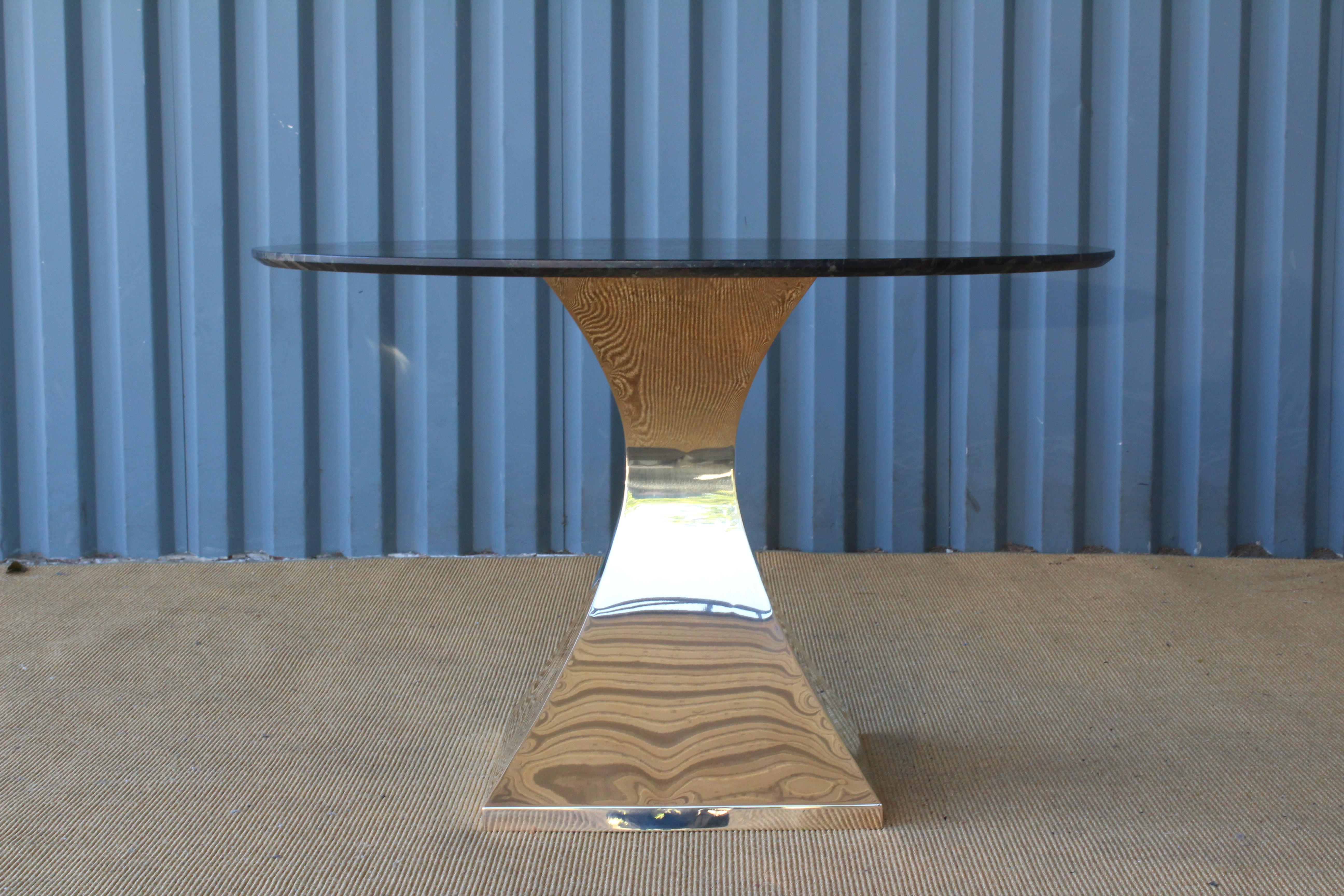 Table with a natural quartz stone top on a brass plated pedestal base.