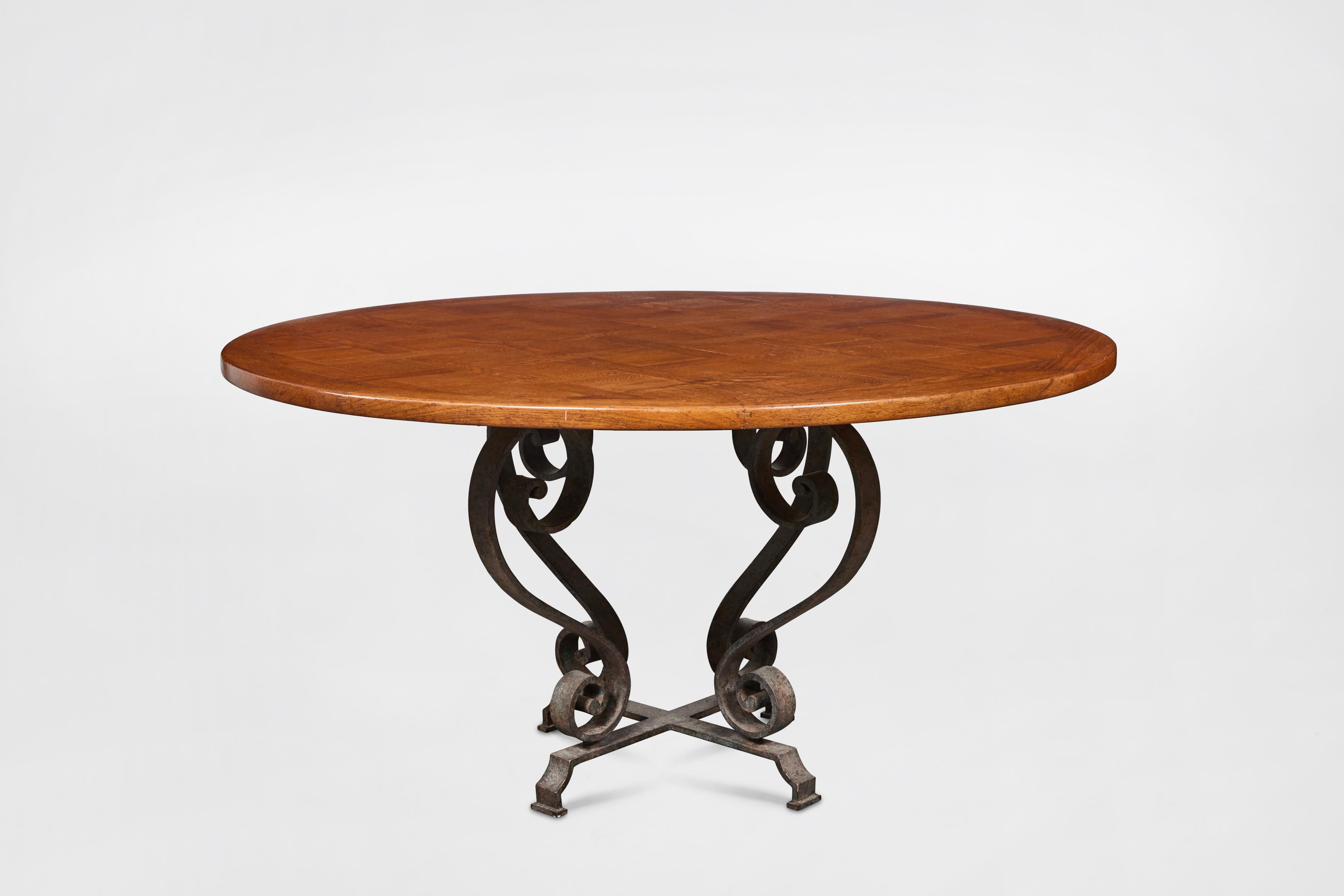 Custom made dining table with round mahogany top and wrought iron base. Made by John Hall Designs, Los Angeles, circa 1990. 