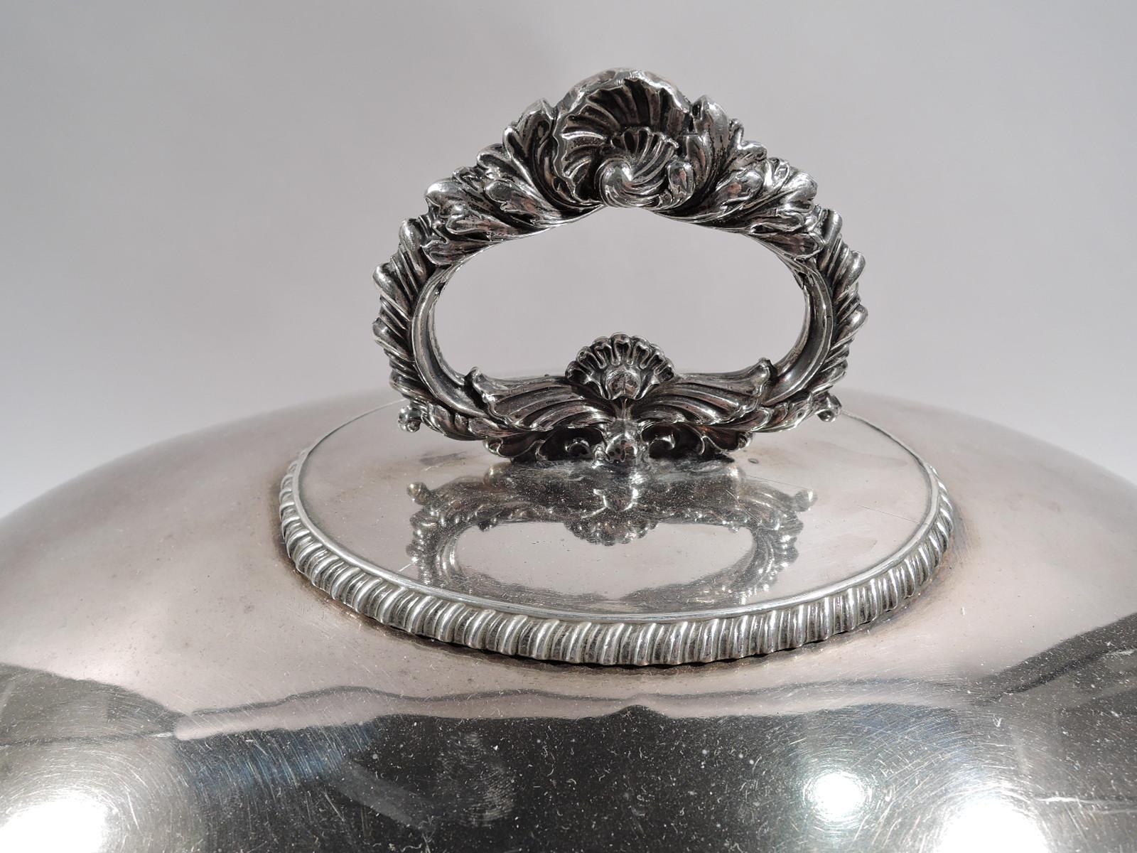 Group of 3 Sheffield plate serving domes. Made by Matthew Boulton in Sheffield, circa 1820.

Large and ovoid with reeded rim and cast scrolled ring finial on leafy scrolled mount. On front is inset sterling silver rectangular frame engraved with