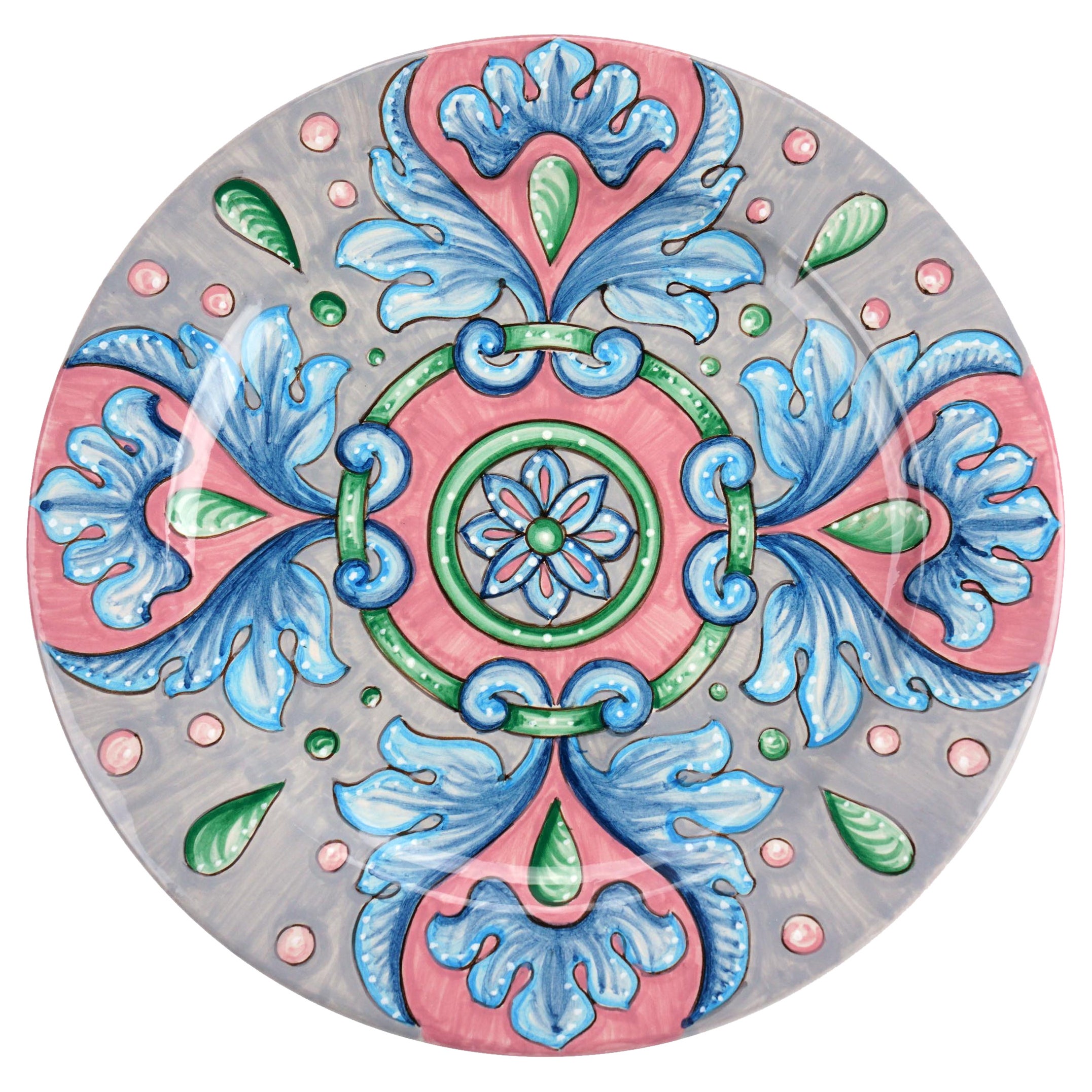 This colorful set of 4 majolica charger plates is handmade and hand-painted in Italy following the original Renaissance painting technique, unchanged over time, which we observe to the letter.
The elegant decoration is composed by a halo of blue