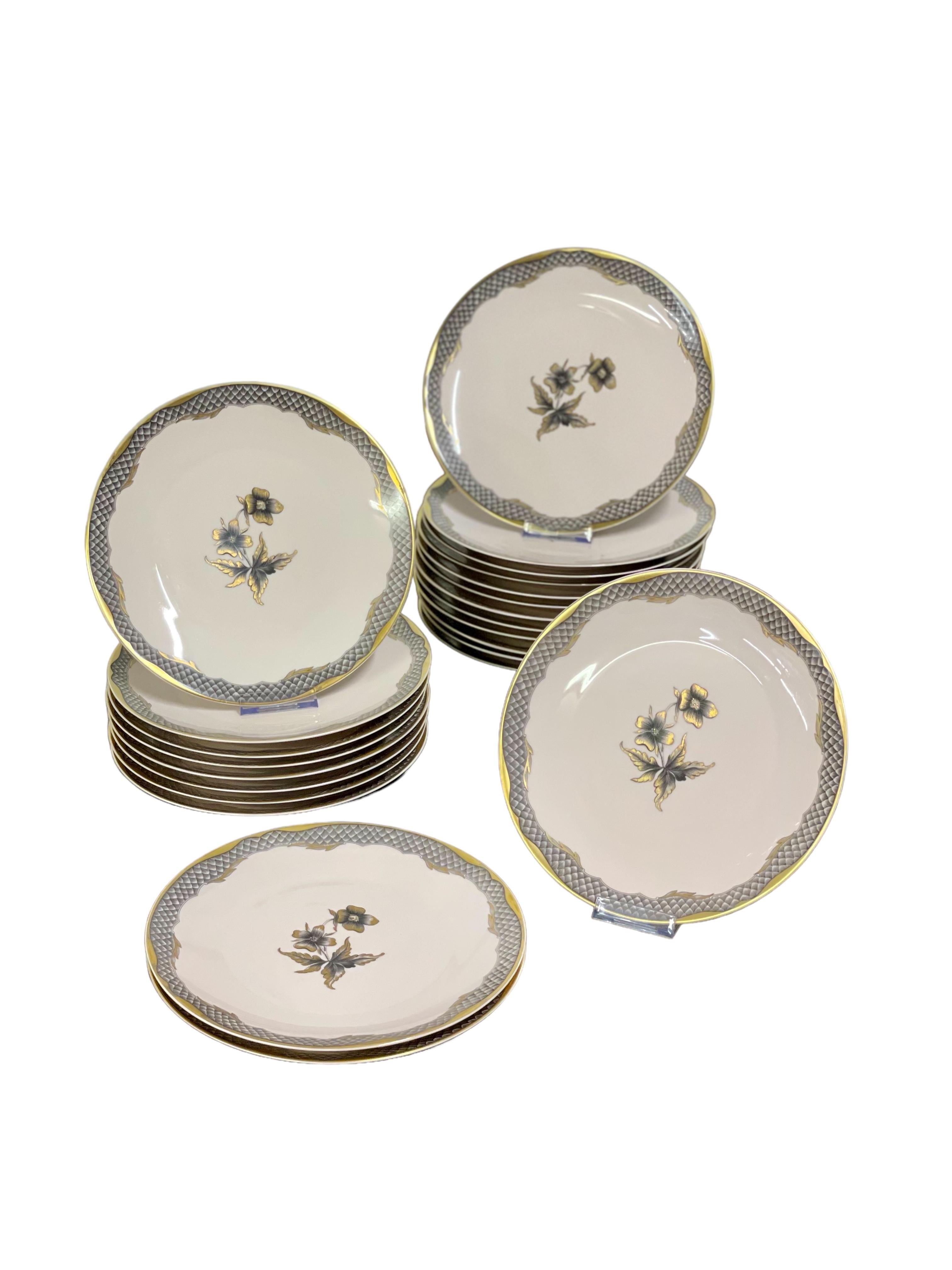 An unusual and very elegant dinner service in fine Limoges porcelain, from the celebrated porcelain manufacturer Raynaud & Cie, and decorated in style by Georges Delille. Each piece in this set features a stylised floral motif at its centre, framed