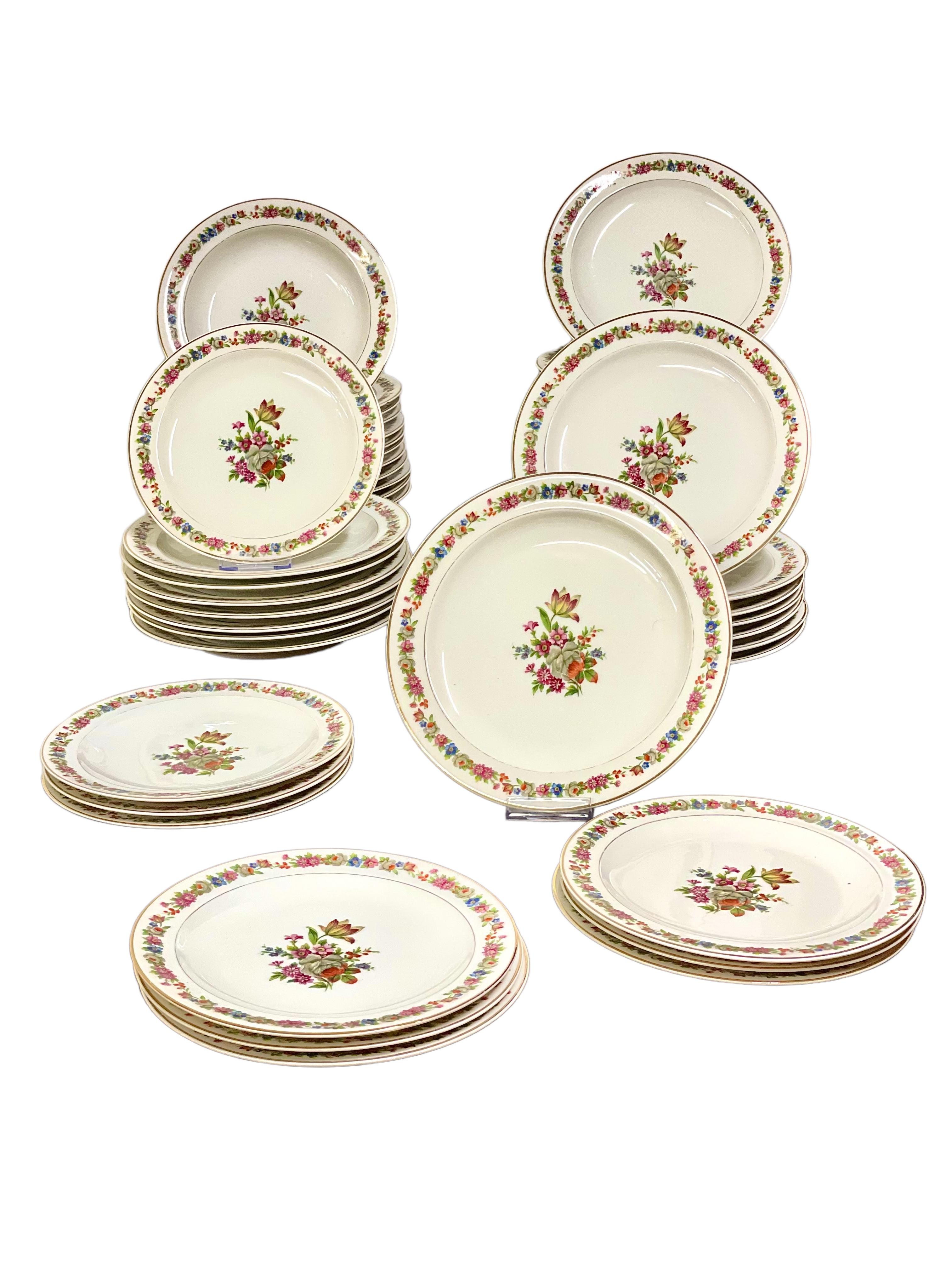 A fine dinner service in Limoges porcelain, dating from around the 1920s and made by renowned porcelain manufacturer Raynaud & Cie. Comprising an assortment of dinner and serving ware, there are 64 pieces in total, each featuring an exquisite