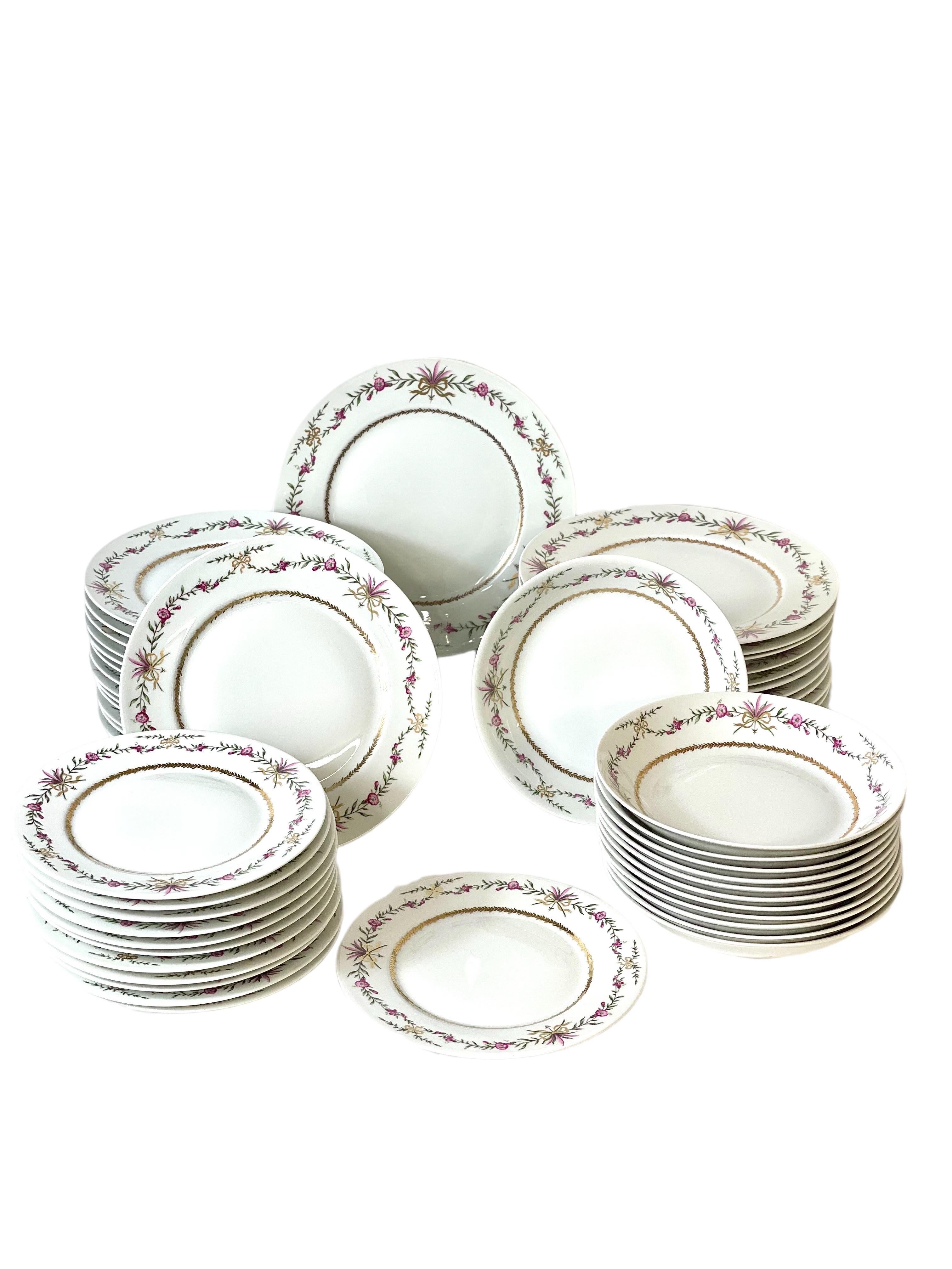 A lovely dinner service of 65 pieces, in delicate Limoges porcelain and stamped with the maker's mark of 'Raynaud'. Sumptuously decorated with hand painted garlands of pink bell- shaped flowers and delicate green foliage spilling from delicate