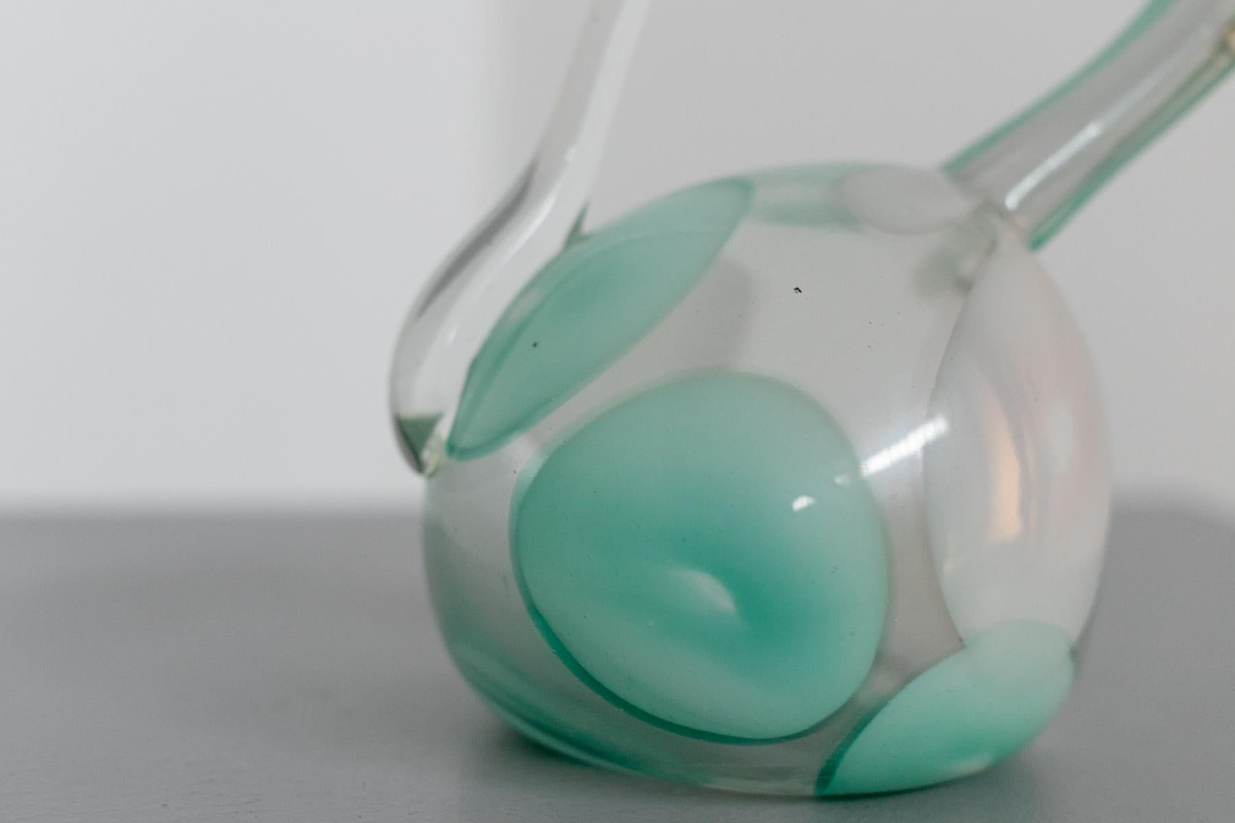 Rare and particular vase in Murano glass by Dino Martens of the '50s.
It has a particular shape, worked with transparent blown glass with shades of intense aqua green. The vase has a very asymmetrical shape and this is its strong point.
Suitable