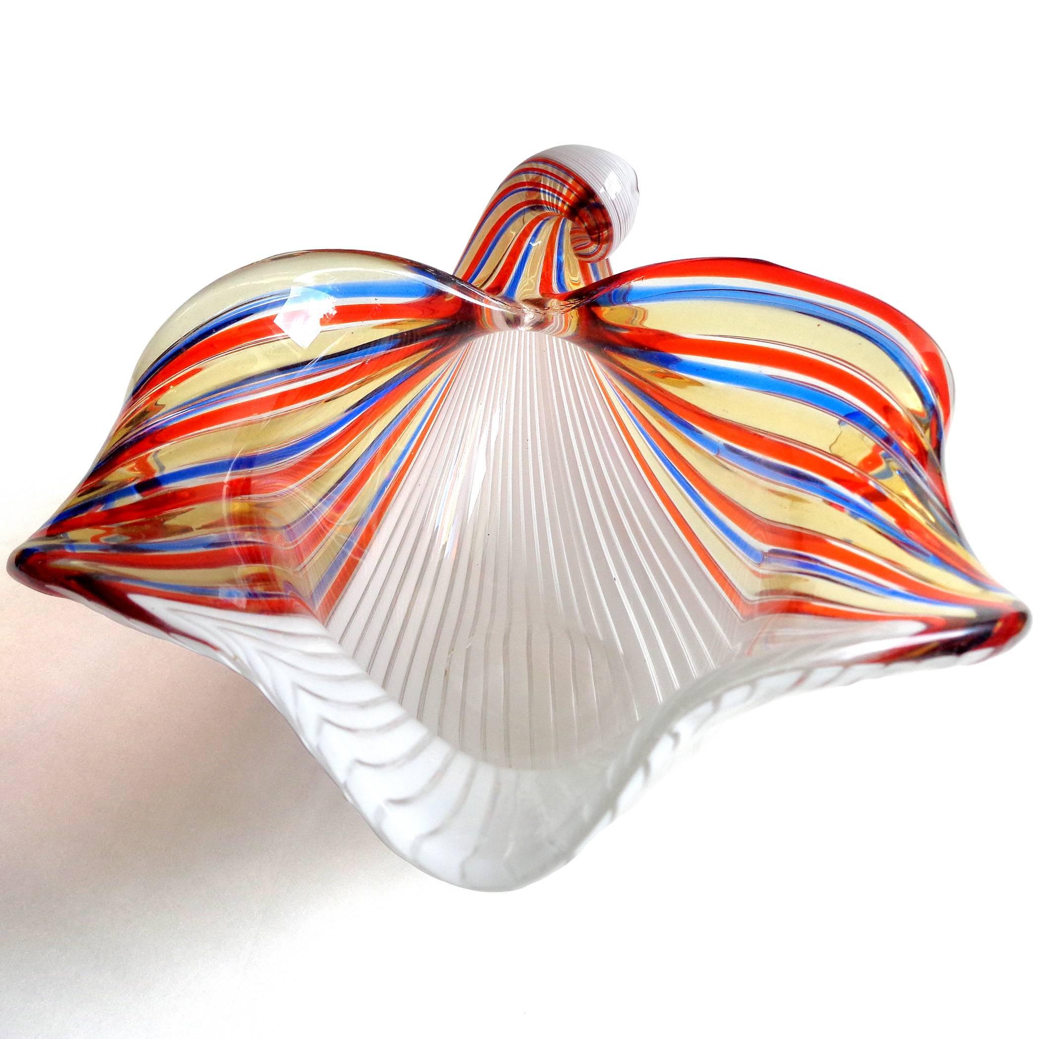 Beautiful Murano hand blown white, blue, yellow and red ribbons Italian art glass shell bowl. Documented to designer Dino Martens for Aureliano Toso, circa 1950s. Published. The piece has a gorgeous shape with curling tail and curved in sides. Sits