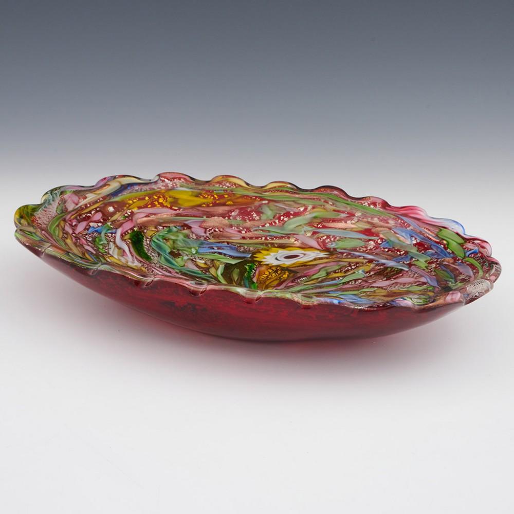 Heading : Arte Vetraria Muranese (AVeM) Tutti Frutti dish
Date : c1950
Origin : Murano, Italy
Bowl Features : Decorated with brightly coloured zanfirico and filigree canes with silver and gold foil inclusions and red base. Crimped rim.
Type :