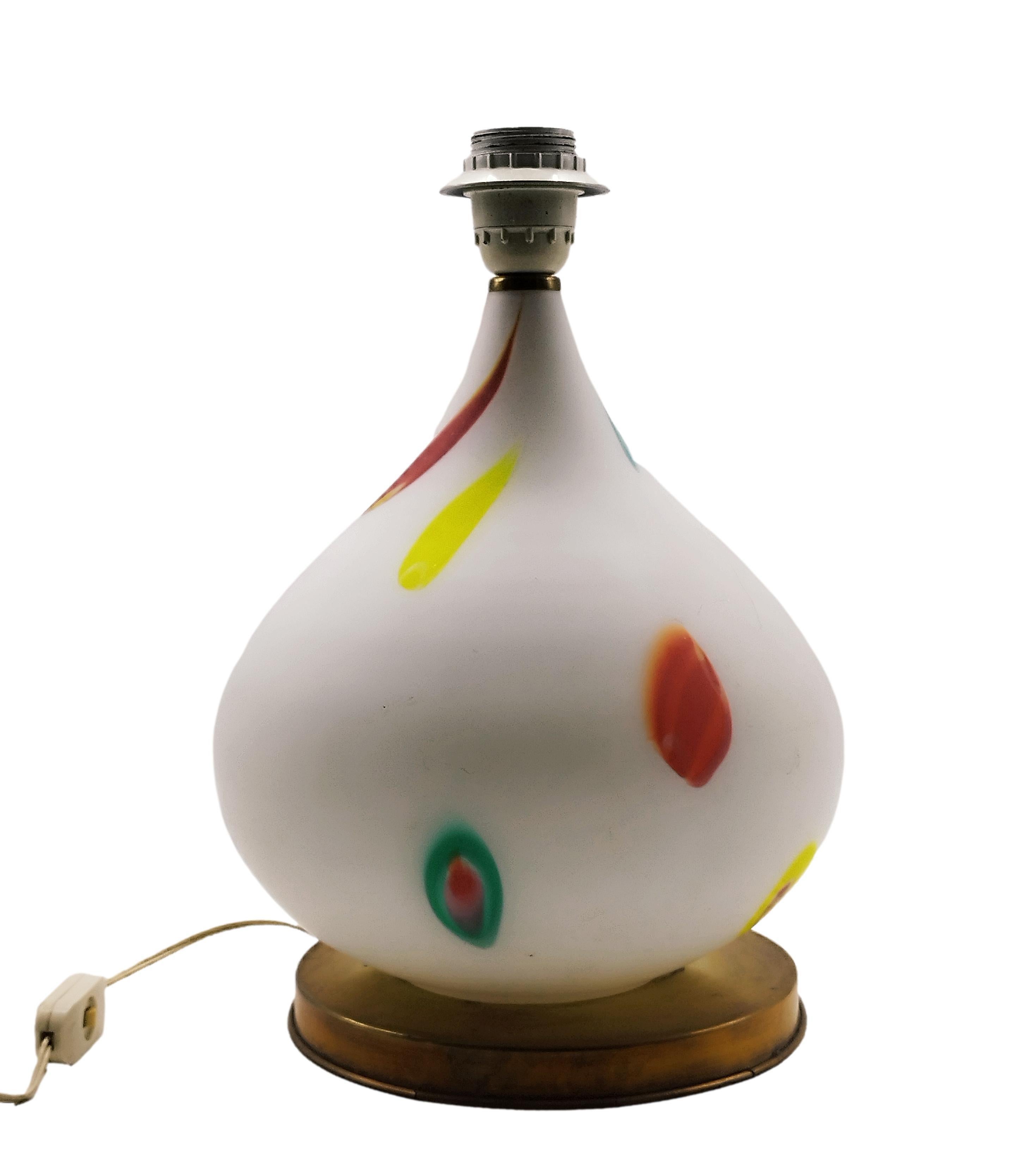 This hand-blown Murano glass table lamp with colorful details rests on a brass base.  It remains in good original condition.