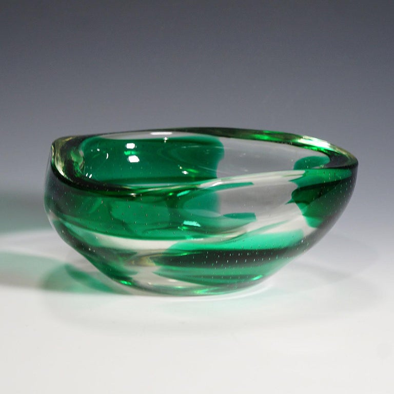 A large Venetian Sommerso glass bowl designed by Dino Martens and manufactured by Aureliano Toso in the 1940s. Thick clear glass with rectangular green spots and bubble areas.

Lit.:
marc heiremans, Dino Martens, muranese glass designer