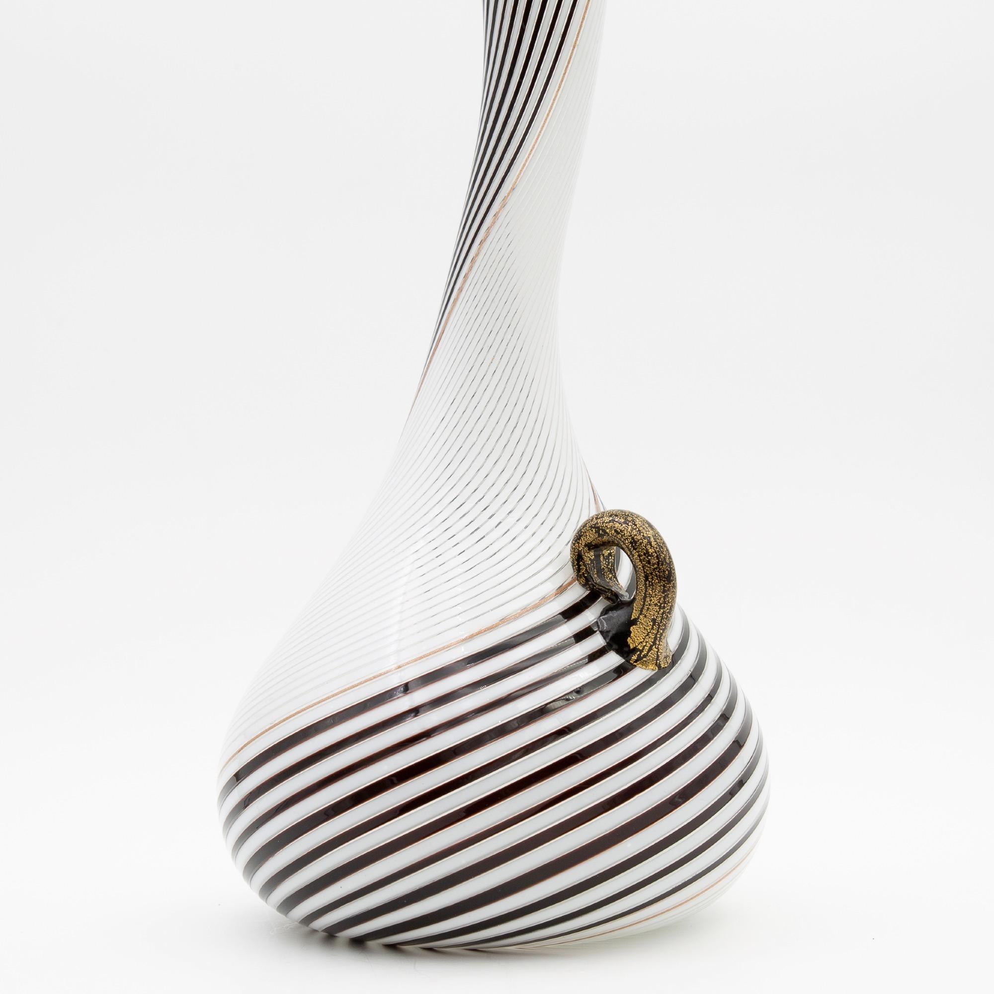 Mezza Filigrana Bianca nera technique blown glass vase
White and black mezza filigrana goose neck vase (Model 5359) - Documented in numerous books on Dino Martens work and Murano glass work in general.
This piece is known as model 5359
The handle