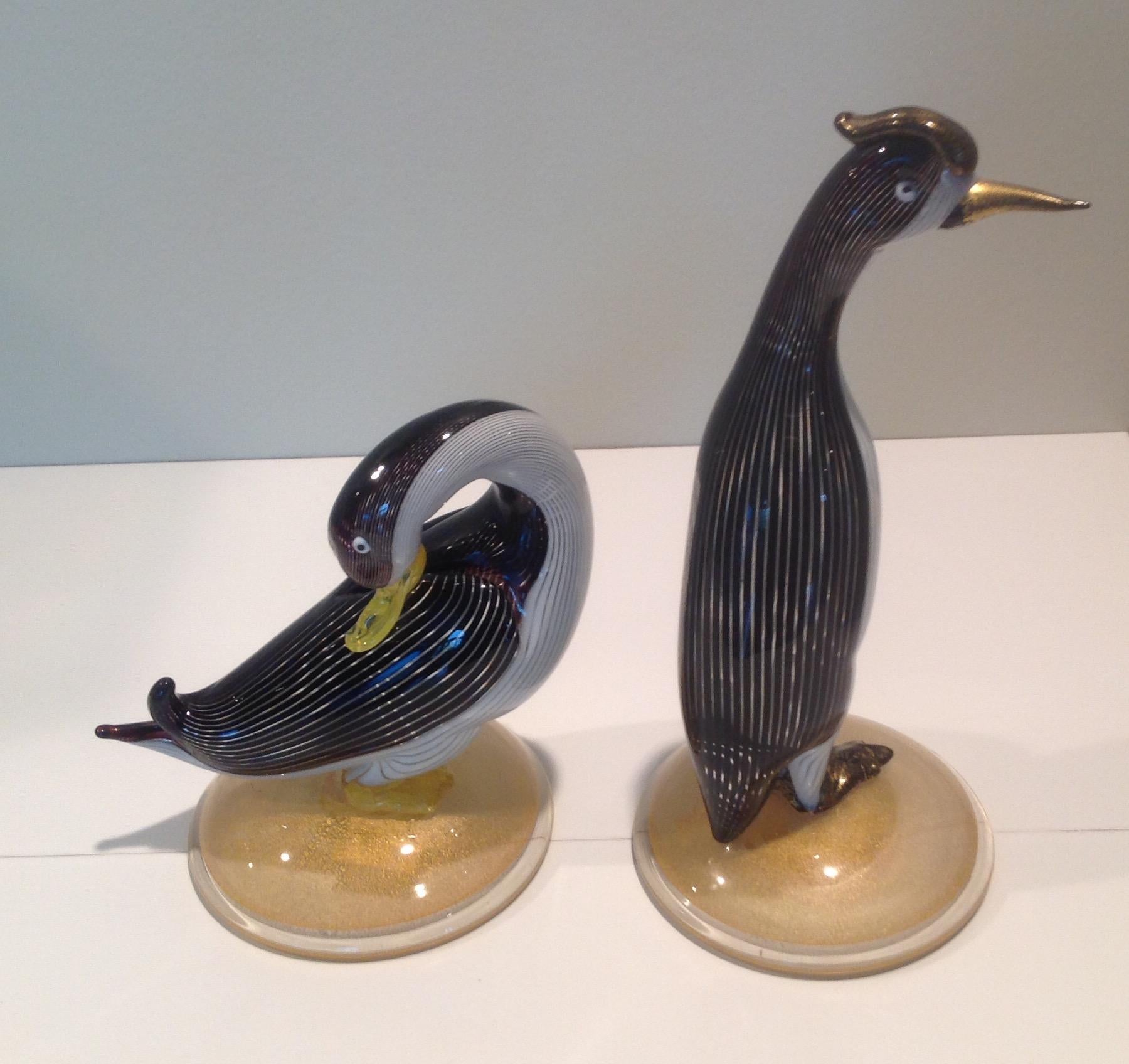 Rare pair of Dino Martens for Aureliano Toso Murano half filligree birds, circa 1954. Both retain original labels. Duck is 6.75 inches tall, by 6.25 inches wide, by 4.5 Inch base. The bird is 10 inches tall, with a 4.5 inch base.