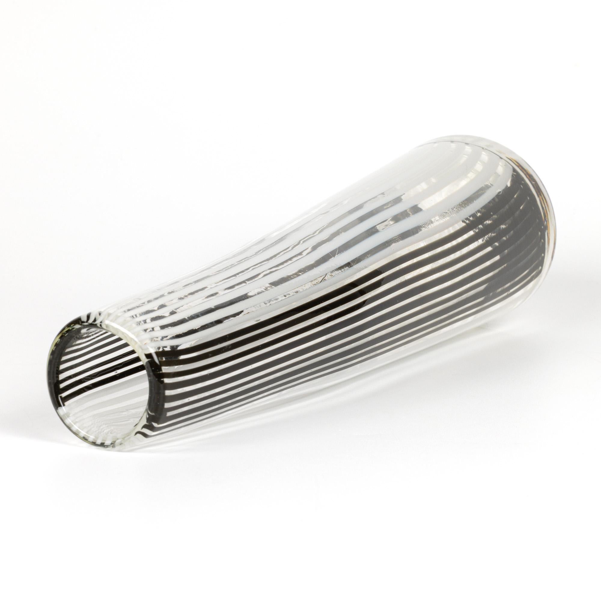 A stylish Italian Murano Bianca Nero art glass vase attributed to Dino Martens (Italian, 1894-1970) and dating from the 1950’s. The hand-blown organic form clear glass vase is of tall graduated cylindrical shape with a slight angled twist to the