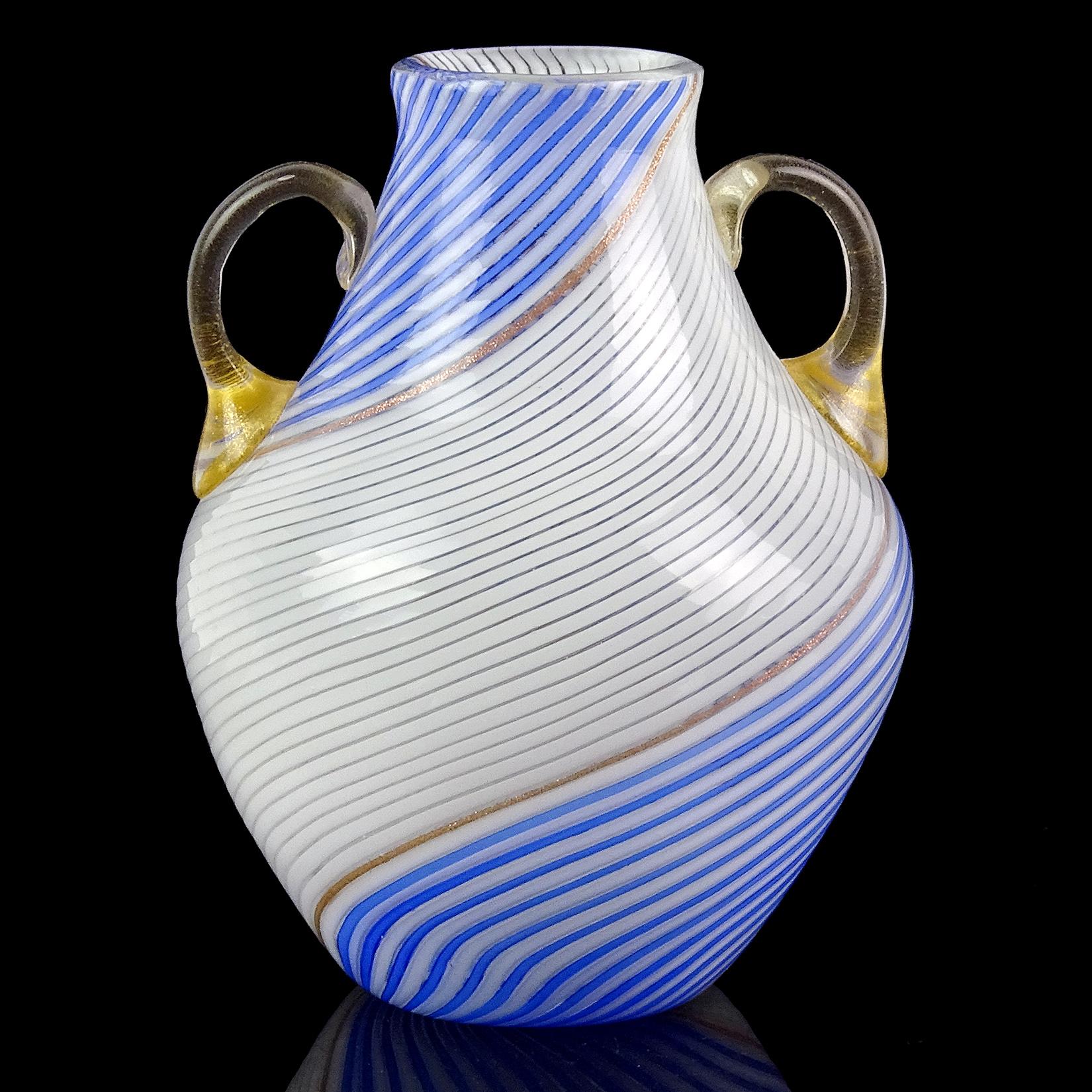 Beautiful vintage Murano hand blown white and blue ribbons Italian art glass flower vase. Documented to designer Dino Martens for Aureliano Toso. The vase has a ribbon of glittery copper aventurine dividing the colors. It also has double gold leaf