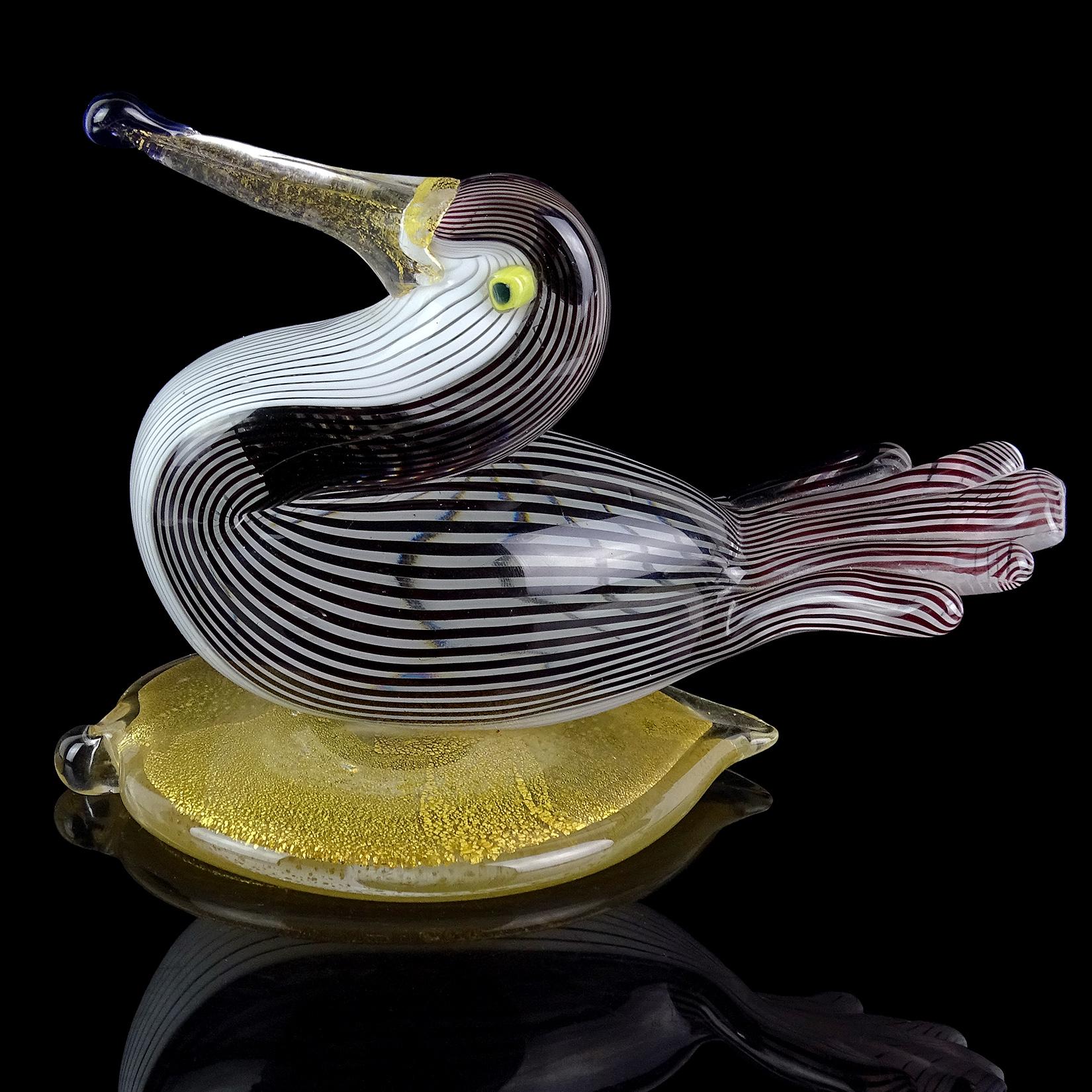 Beautiful vintage Murano hand blown black and white ribbons Italian art glass water bird sculpture on gold leaf base. Documented to designer Dino Martens for Aureliano Toso, and published in his book (see last photo), circa 1954. It is a slight