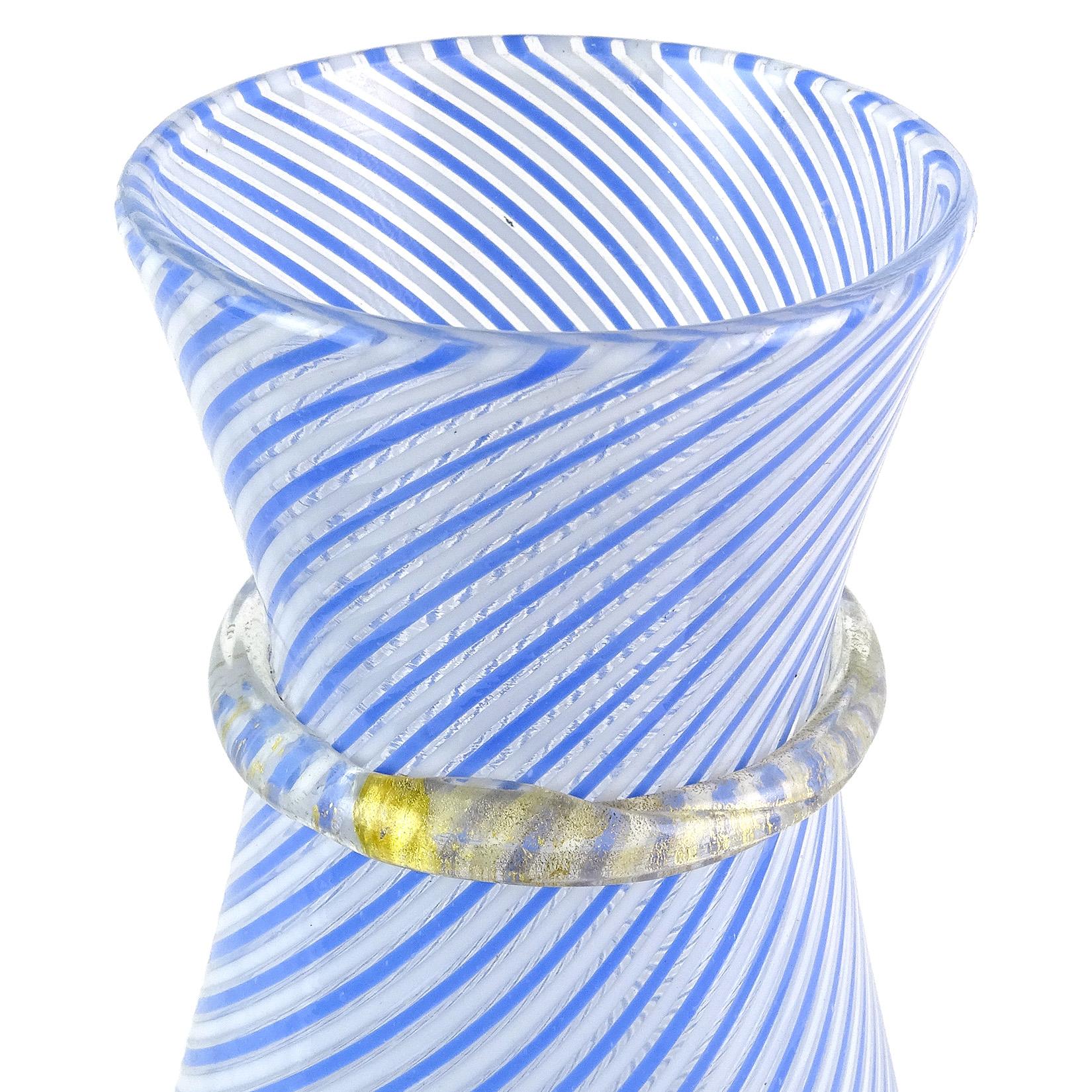 Beautiful Murano hand blown blue and white Filigrana ribbons and gold flecks Italian art glass flower vase. Documented to designer Dino Martens for the Aureliano Toso company, circa 1950s, model 2815. It has a nautical feel, with soft powder blue