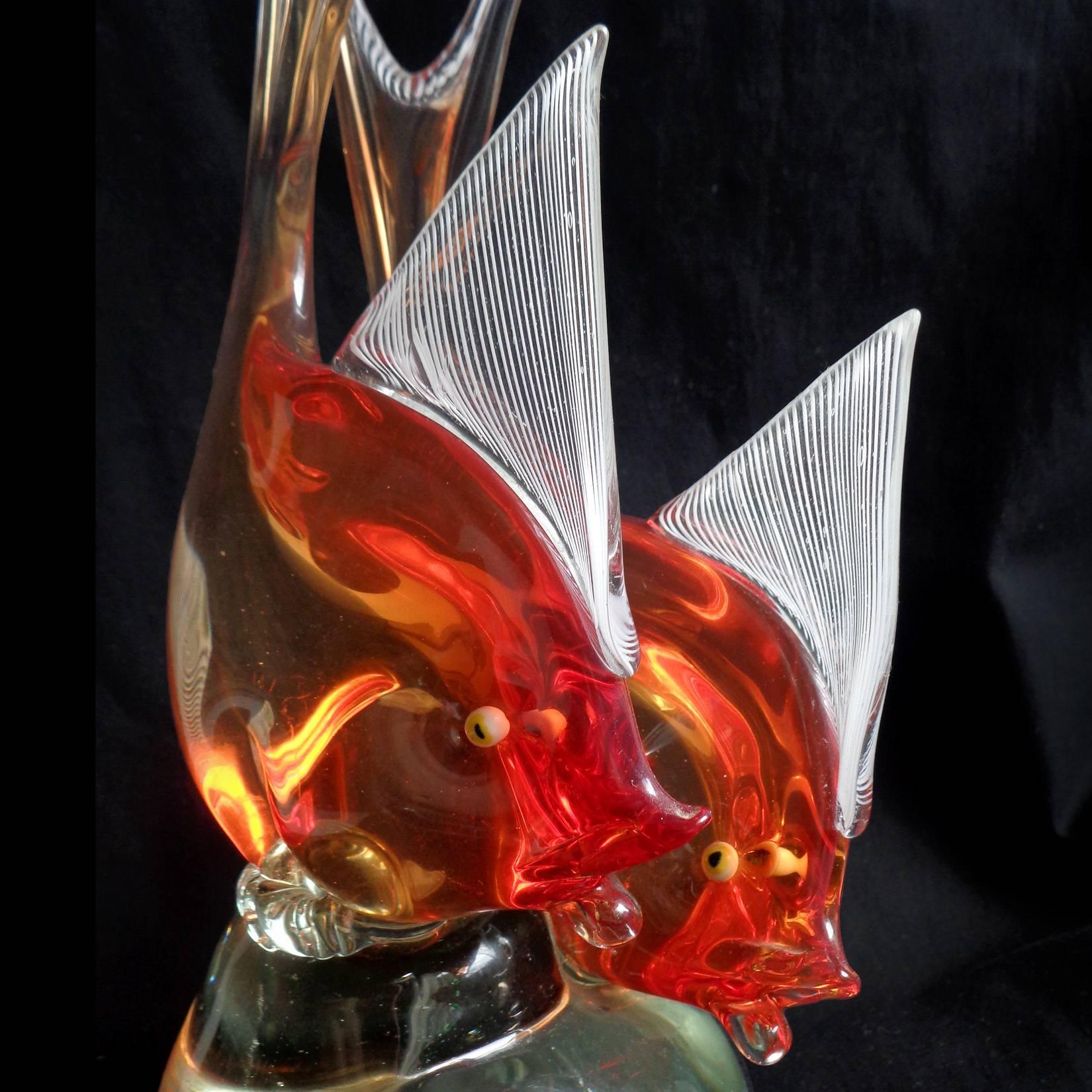 Beautiful vintage Murano hand blown Sommerso orange Italian art glass double fish sculpture. Documented to designer Dino Martens for Aureliano Toso, circa 1954. Published in his book (see photo), model 6191. The fish have white Latticino ribbons on