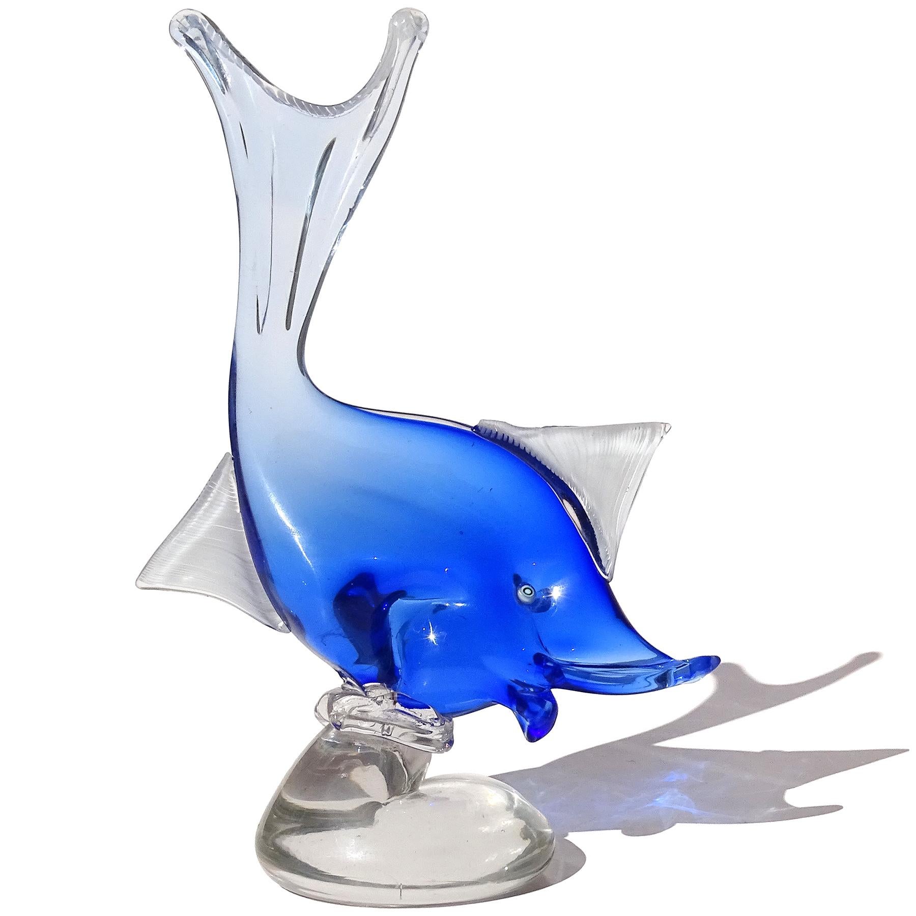 Beautiful vintage Murano hand blown Sommerso sapphire blue to clear Italian art glass fish on base sculpture. Documented to designer Dino Martens for Aureliano Toso, circa 1950s. Published in his book (see photo), model 6180, and a later model