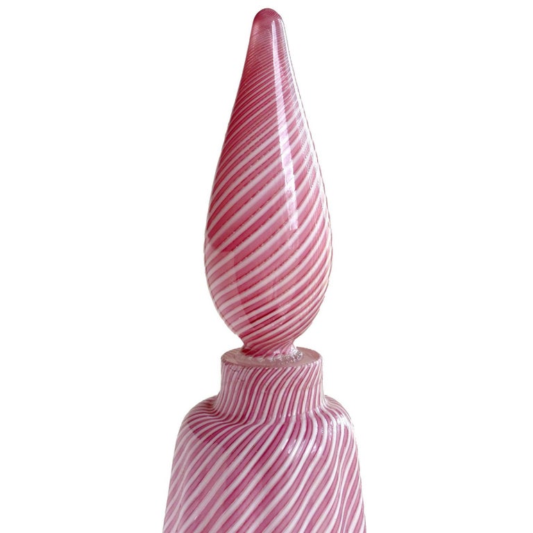 Beautiful and large, vintage Murano hand blown pink and white ribbons Italian art glass decanter. Documented to designer Dino Martens for Aureliano Toso. Has the original stopper and a ribbed design to the body. Would make a great display piece on