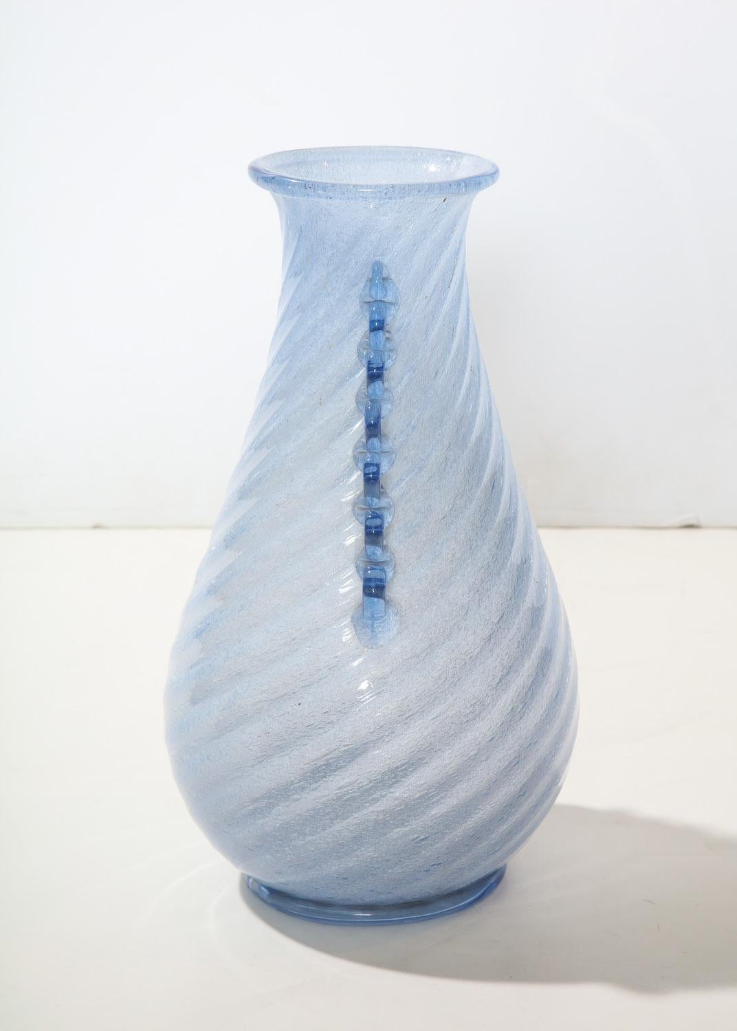 Model #884, produced by Aureliano Toso, on the island of Murano. This beautiful vase designed by Dino Martens in pale lavender glass with swirled ribbing and applied side decorations and foot.