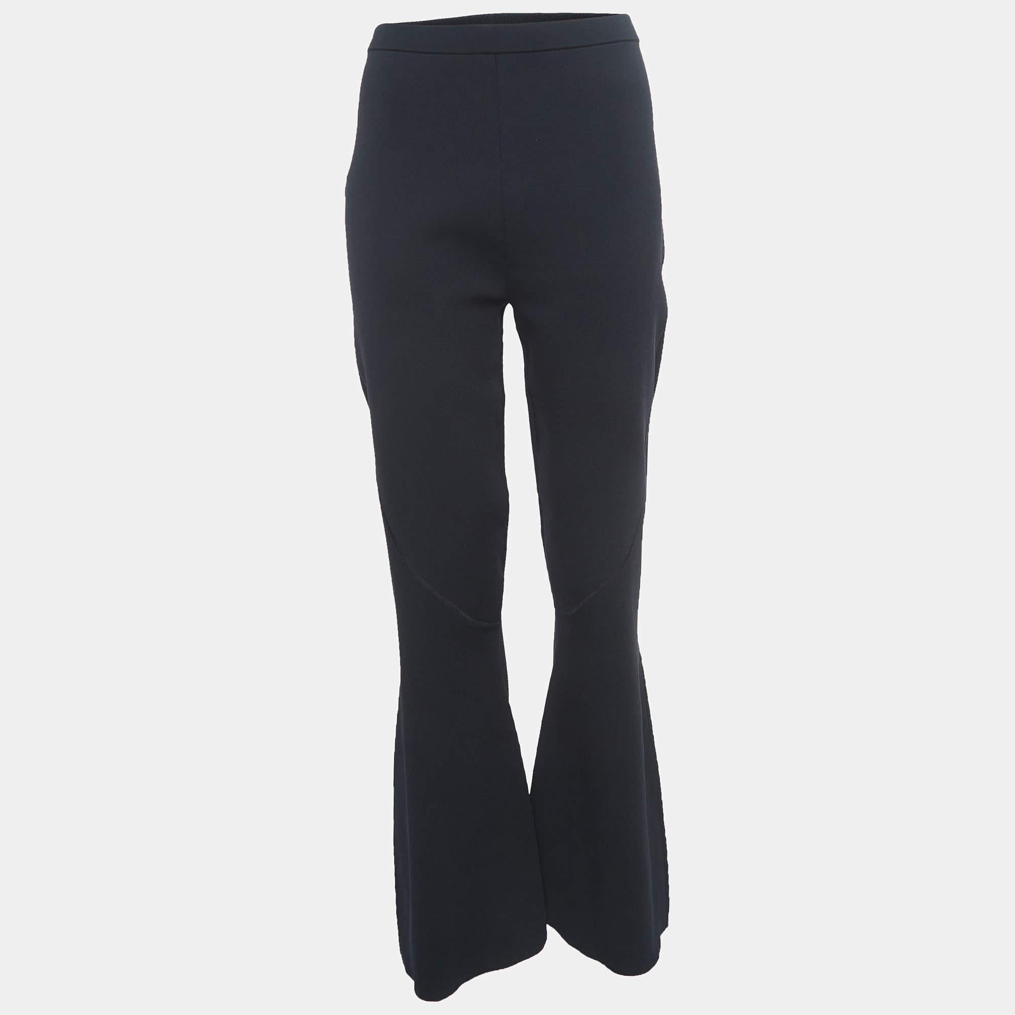Dion Lee's pants exude modern elegance with a luxurious knit fabric. The wide-leg silhouette offers a sophisticated and comfortable fit, while the black color adds versatility. Perfect for effortlessly transitioning from day to night, these pants
