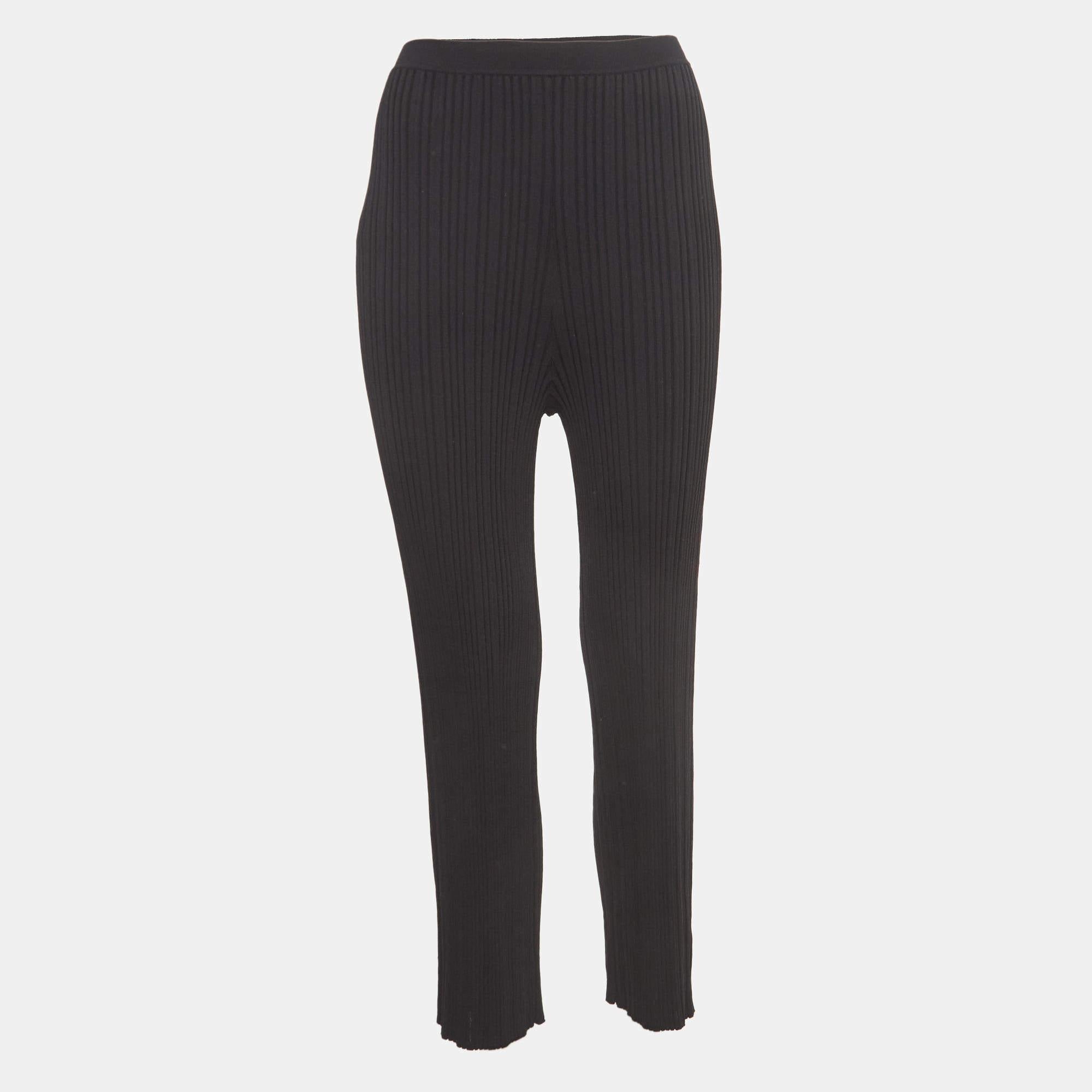 Dion Lee's float pants are a chic blend of comfort and style. Crafted from rib-knit fabric, these pants feature an elasticated waist for a customizable fit and a relaxed, flowing silhouette that effortlessly combines casual sophistication with