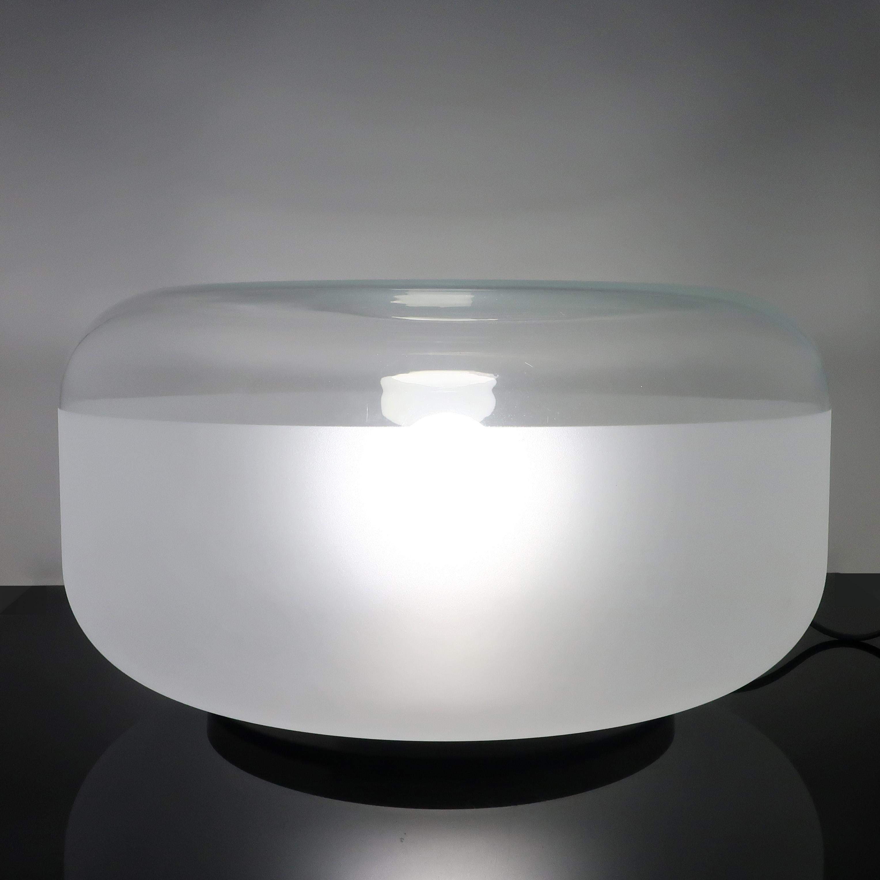 A lovely 2003 glass table lamp designed by Pearson Lloyd for ClassiCon. The top of the glass shade is clear while the sides and bottom are frosted to throw light that is crisp yet diffused. Glass shade sits on top of an aluminum base that includes a