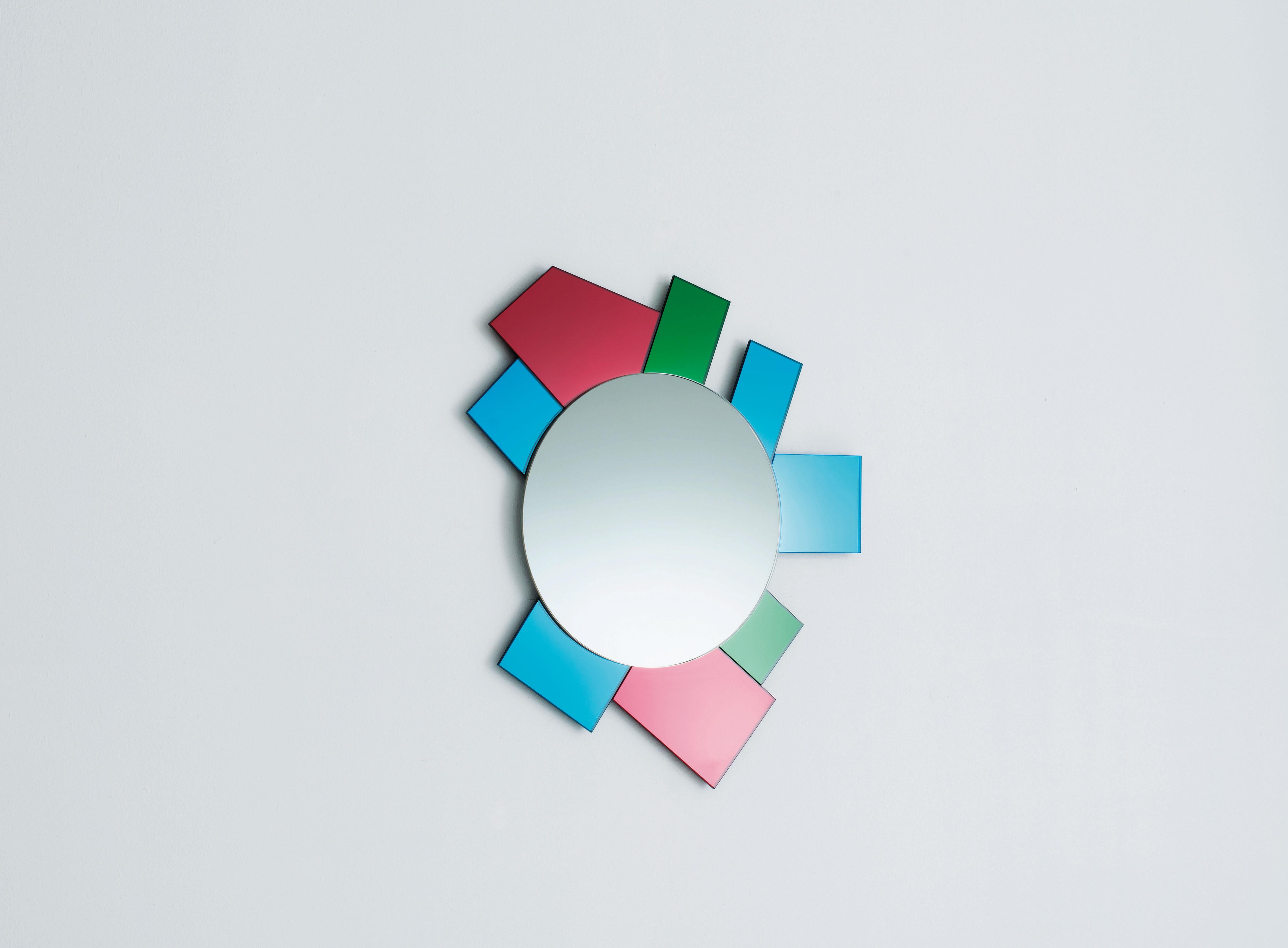 Dioniso6 Gli Specchi di Dioniso wall mirror is from a collection of 6 wall mirrors in different shapes and sizes characterizes by polychromatic frames composed of elements in laminated colored mirror, colored laminated glass and lacquered