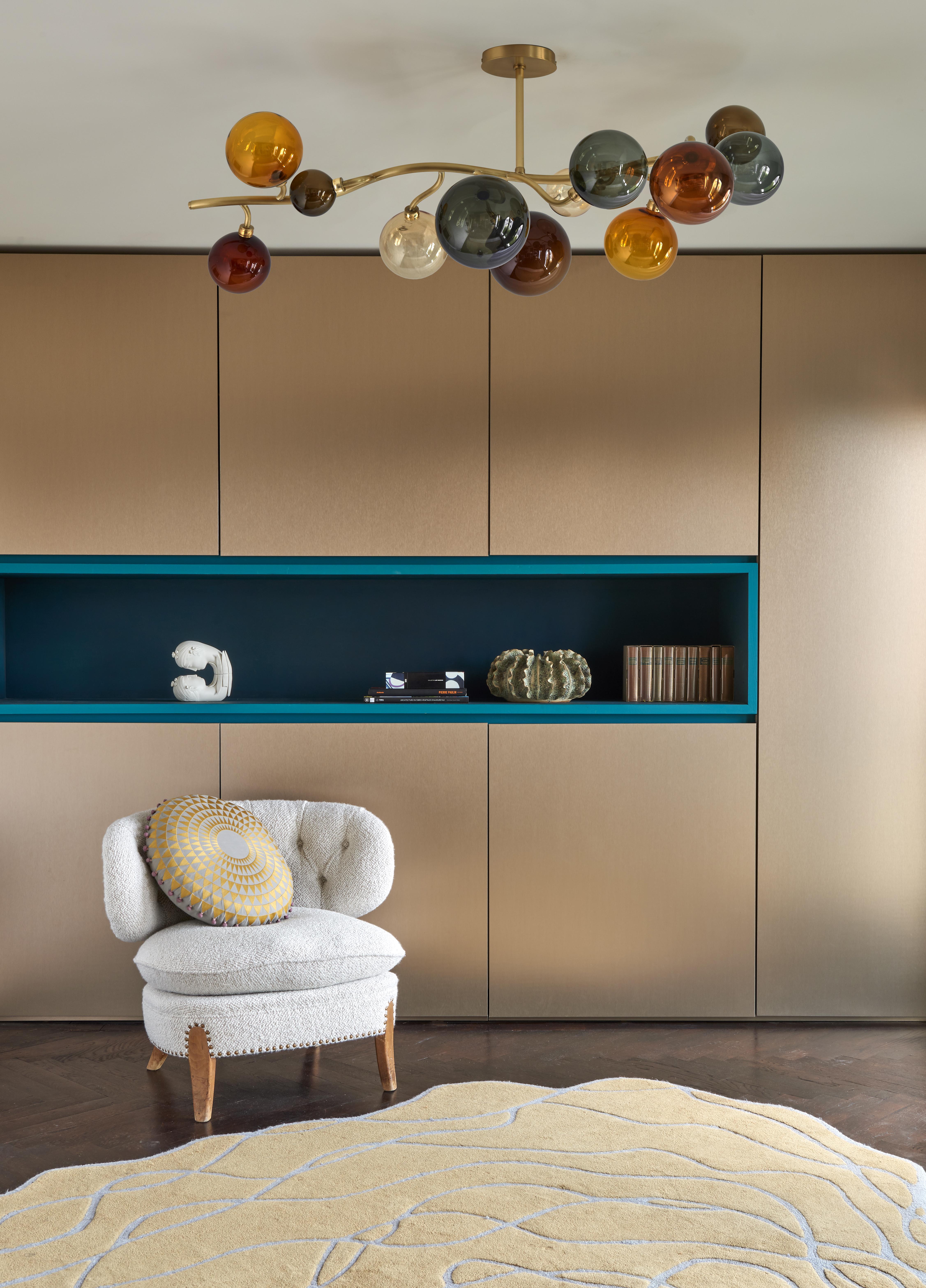 Chandelier in brushed brass with hand-blown glass spheres. 
Artist: Emilie Lemardeley
Handmade in France, 21st century
Glass colors: Smoked grey, light and dark amber, champagne, brown.

Measures: Length: 47.24 in
Width: 23.62 in
Height:
