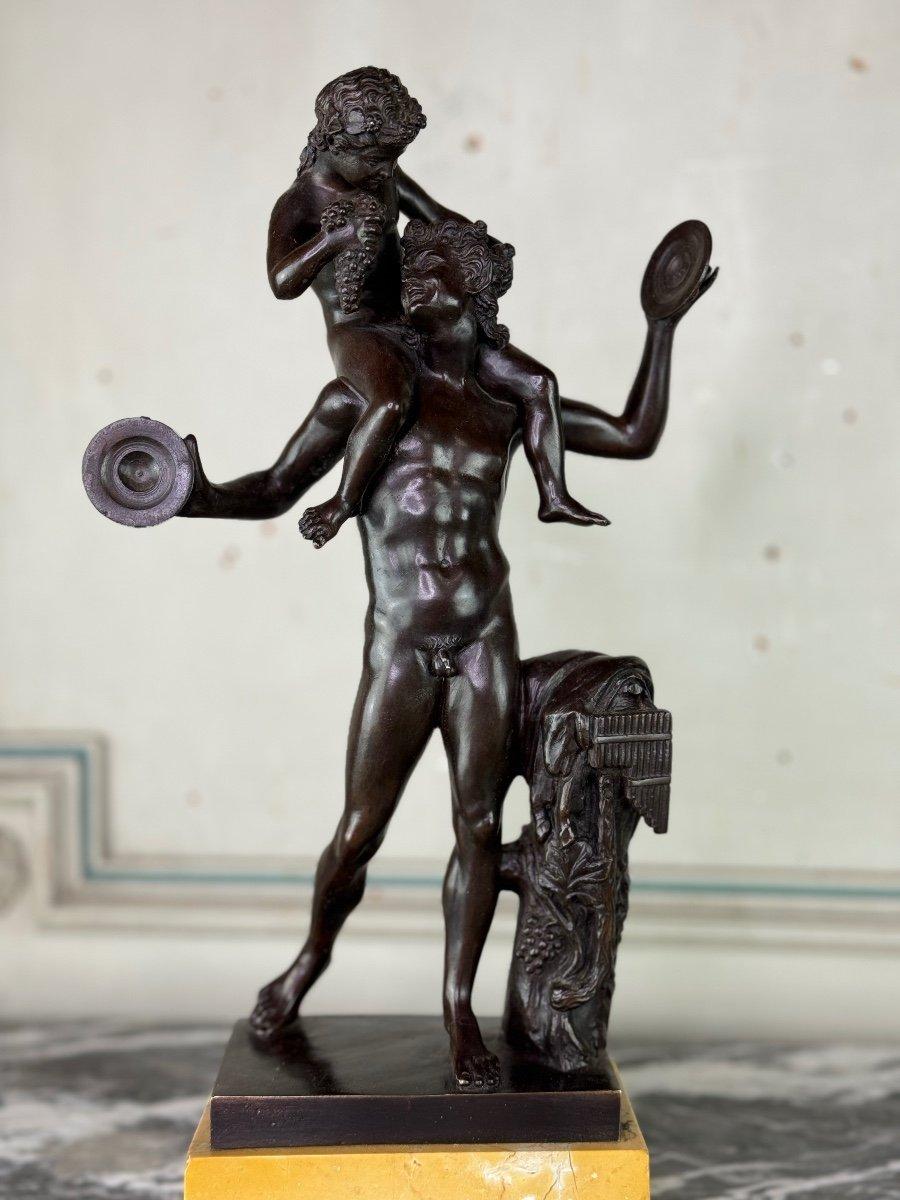 Dionysus on the shoulders of a satyr, bronze after the antique on a yellow base from Siena marble, 

19th century