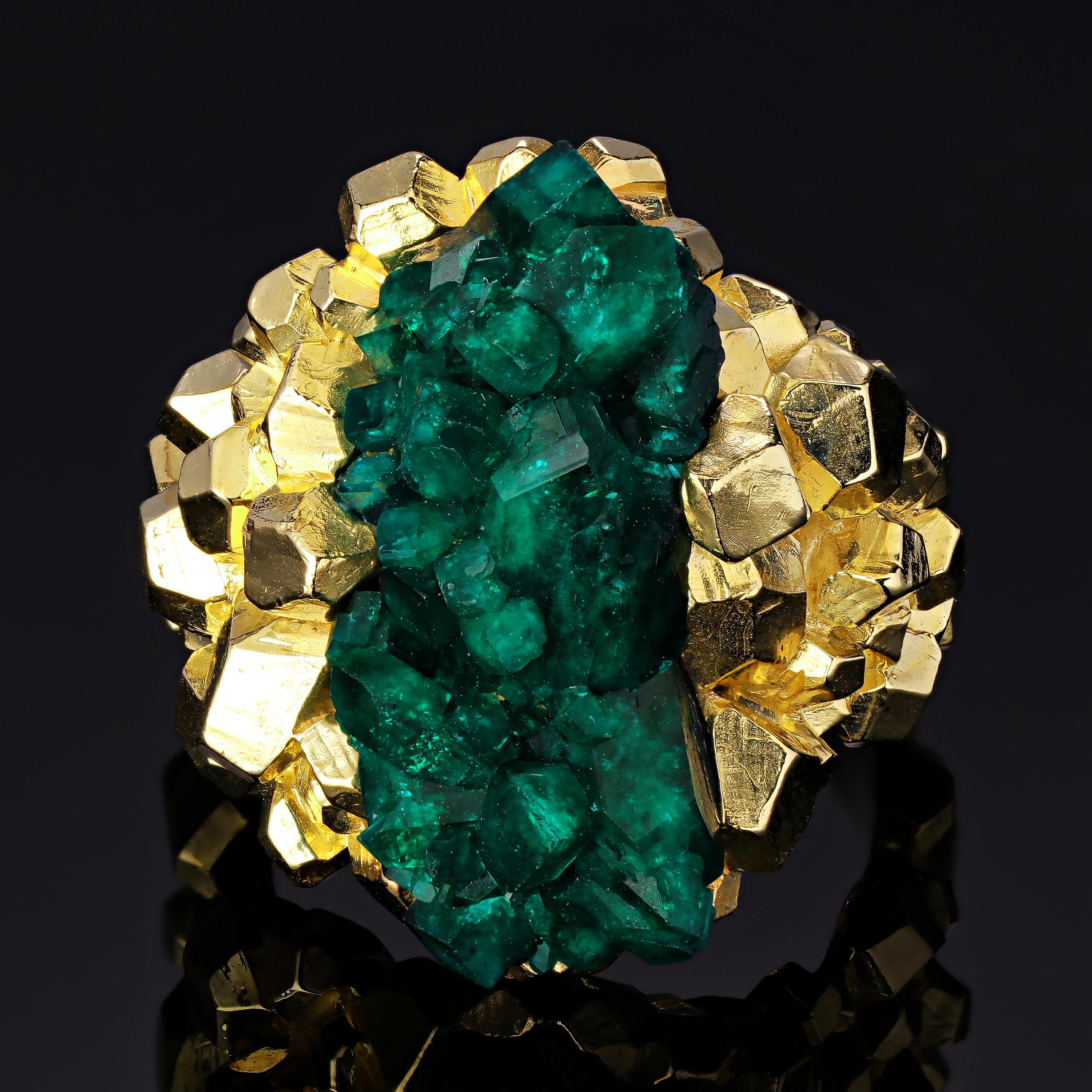 This incredible one of a kind ring showcases the natural beauty of the dioptase crystal, displaying it like a treasure-trove bursting with intense color in the center. Mined from Kazakhstan, this fine quality dioptase exhibits an intense