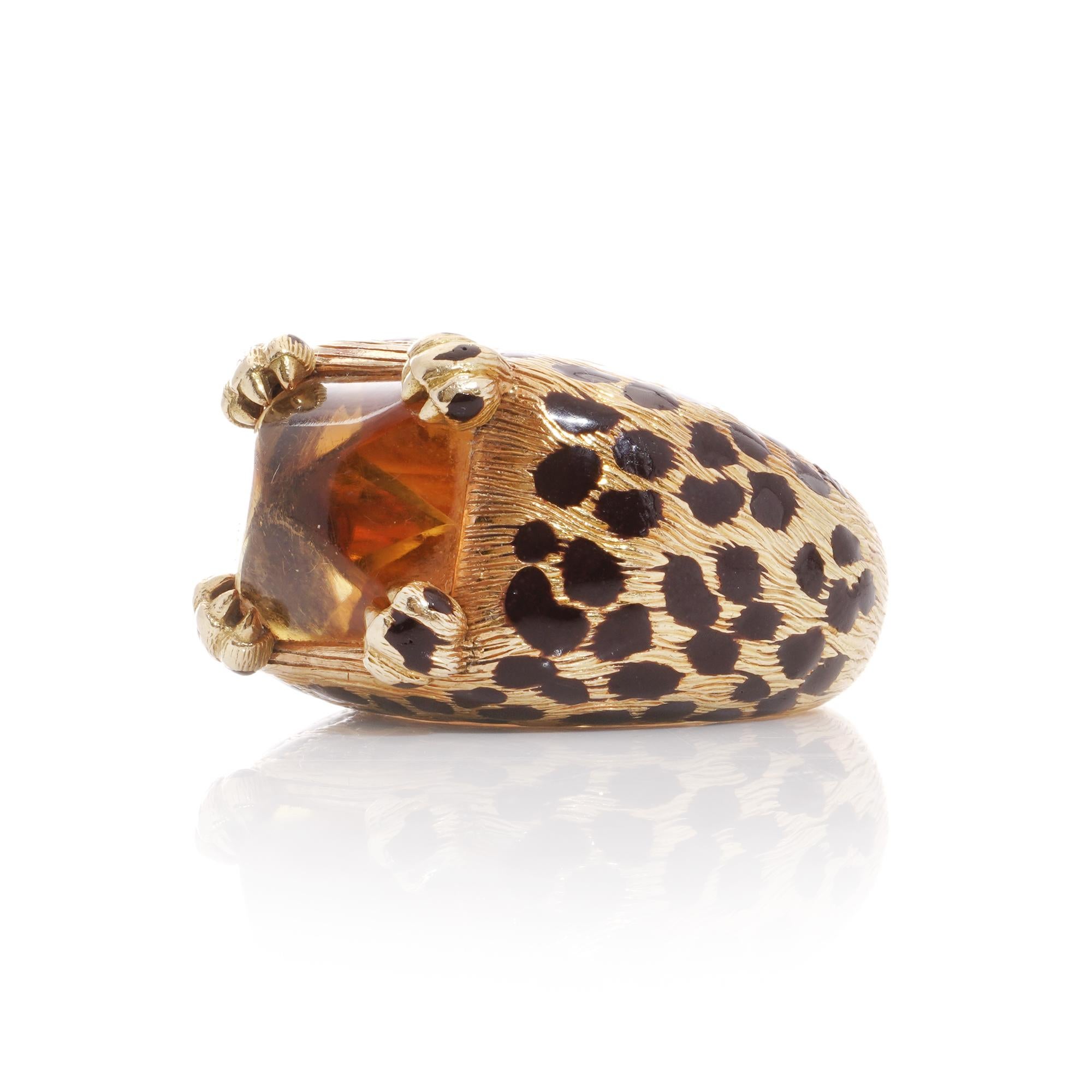 Indulge in the fierce elegance of this captivating domed cocktail ring, where luxury meets untamed beauty. At its heart lies a mesmerizing sugarloaf cabochon-cut citrine, cradled by primal leopard paw motif prongs, all embraced by textured 18k