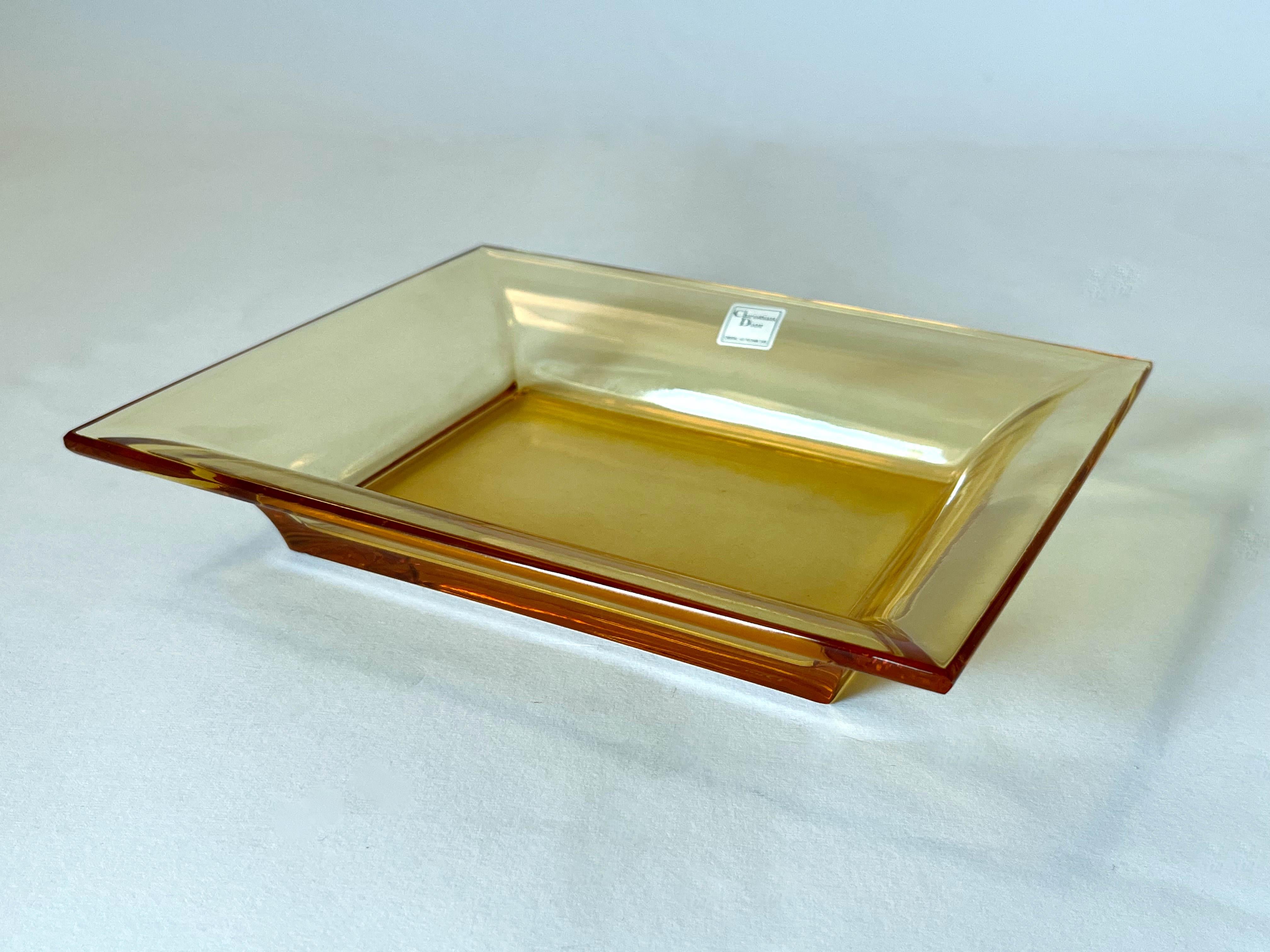 Christian Dior amber rectangular lead glass crystal vide poche, change tray, pocket emptier or ashtray / made in France
Original label on the glass / mark etched on the base / comes in original box
Length: 8 inches / Width: 6.5 inches / Height: 1.5